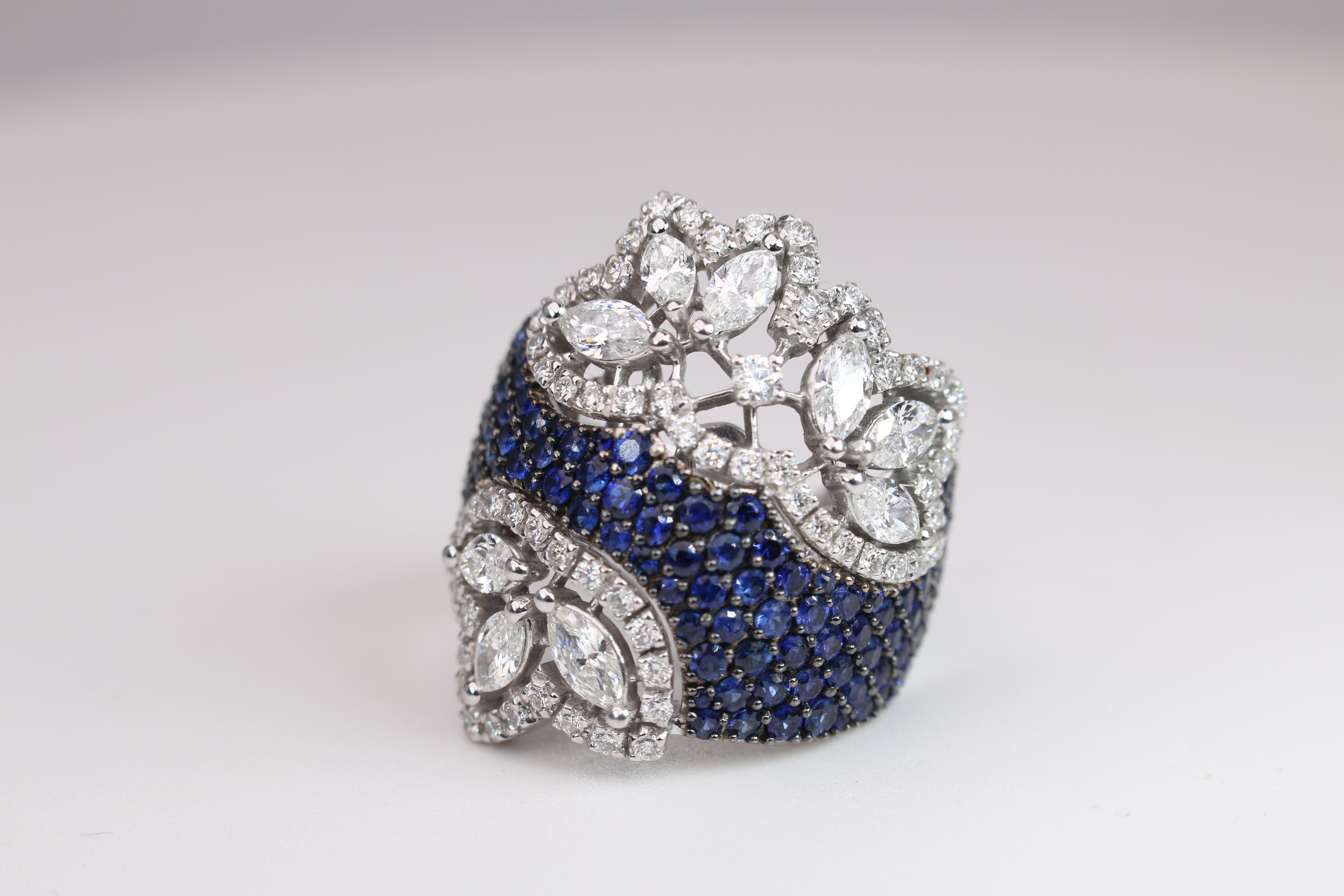 18K White Gold Sapphire (2.18C) with Diamonds (2.30C).  This stunning ring is a sight to see.  it wears comfortably on the finger and has an awesome amount of razzle dazzle sparkle!  