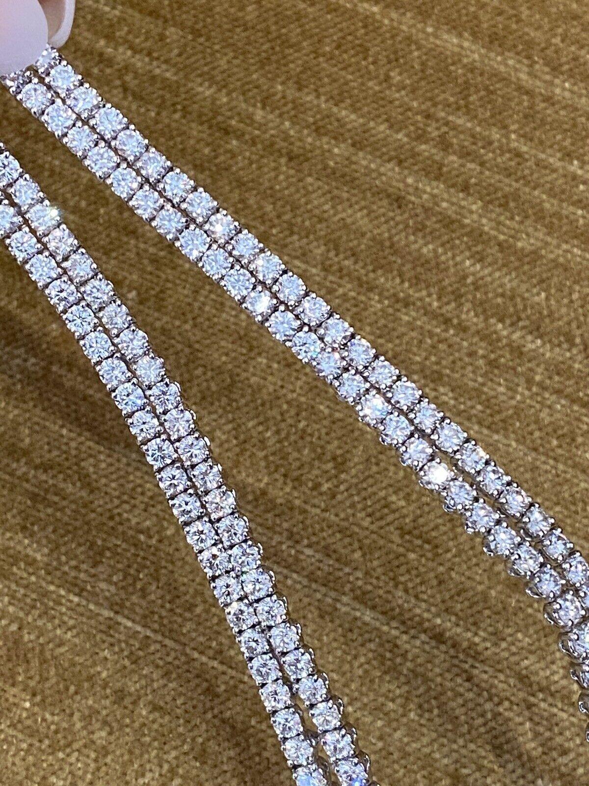 Diamond Y Necklace in 18k White Gold by STEFAN HAFNER
Features
Two rows of Round Brilliant Cut Diamonds that meet with 
a cluster of Rubies and Pink Sapphires and drop down into loops

35.02 carats in total of Diamonds

4 Pear-shaped Rubies
