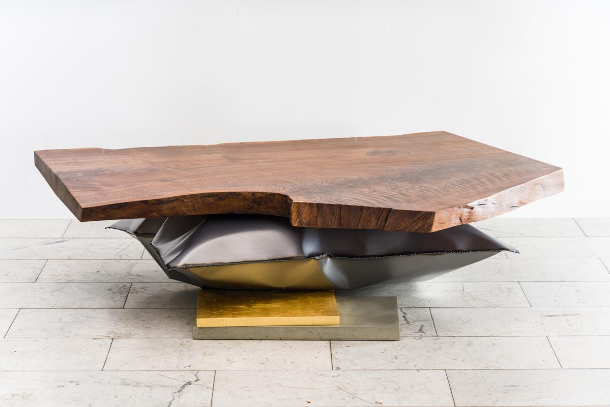 Stefan Rurak’s low table VI expands the artist’s affinity for steel with a new form that juxtaposes buoyancy and rigidity. The low table consists of a magnificent slab of live edge walnut, three inches thick, curiously resting on an