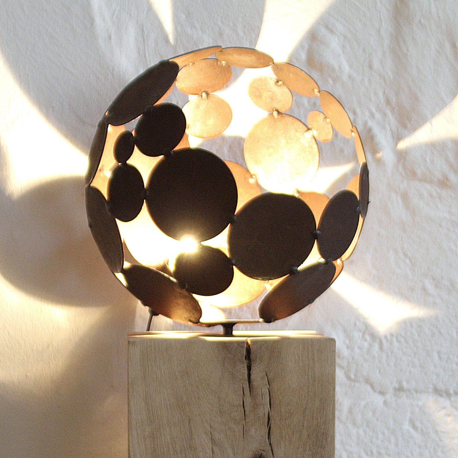 Ball lamp d = 28cm rust with natural oak base 20x20x78cm.
Customization possible and designed in 2010.
Also available to order in stainless steel.

You will find an exceptional and high-quality lamp here, which conjures up a beautiful shadow pattern