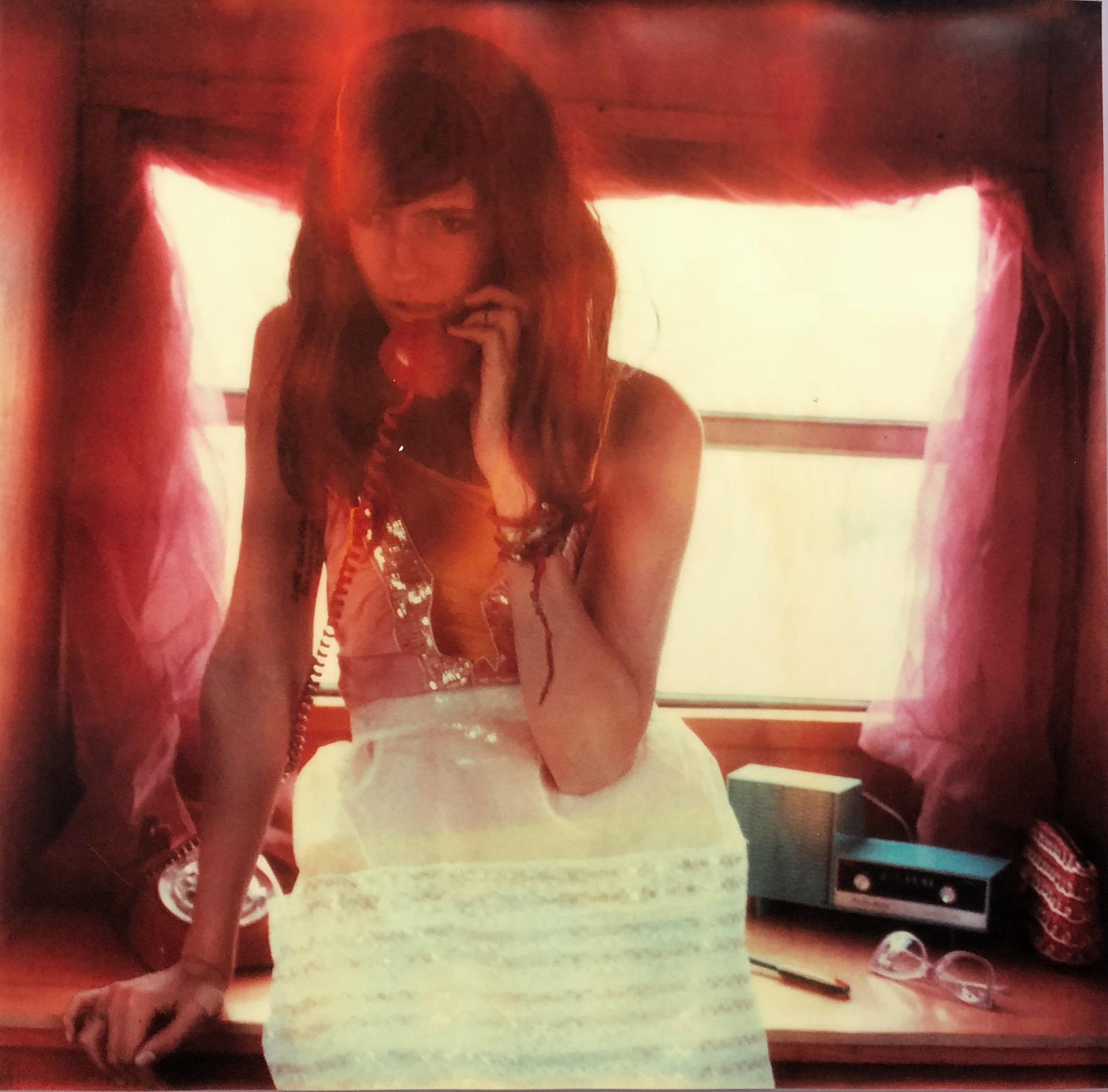 Stefanie Schneider Figurative Photograph - On Hold - The Girl behind the White Picket Fence