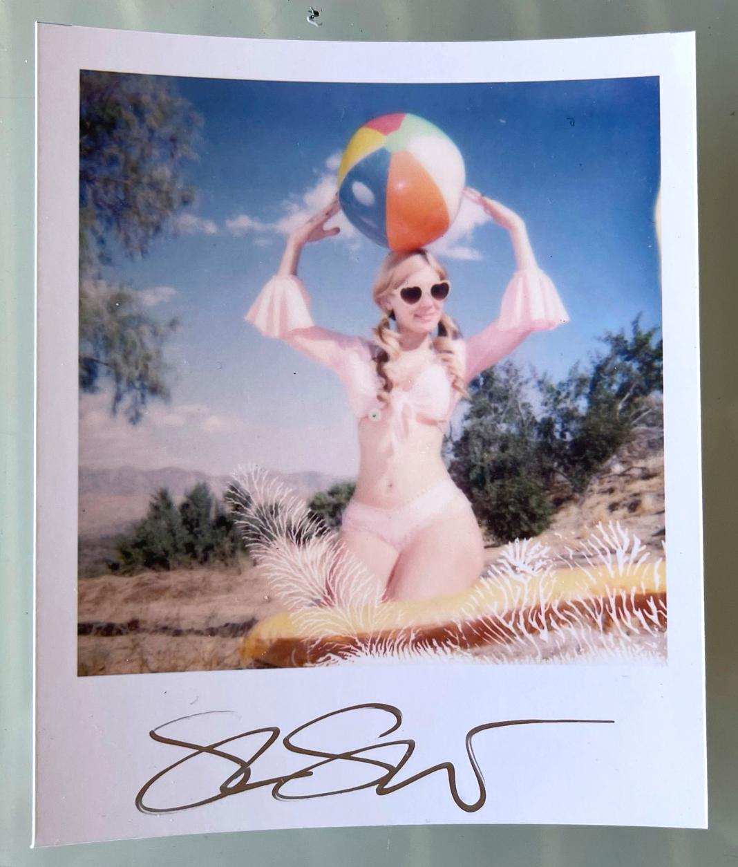 Stefanie Schneider's Mini
Miss Moneypenny with Beachball (Heavenly Falls) -

signed in front, not mounted. 
Digital Color Photographs based on a Polaroid. 

Polaroid sized open Editions 1999-2013
10.7 x 8.8cm (Image 7.9x7.7cm)

Included is a signed