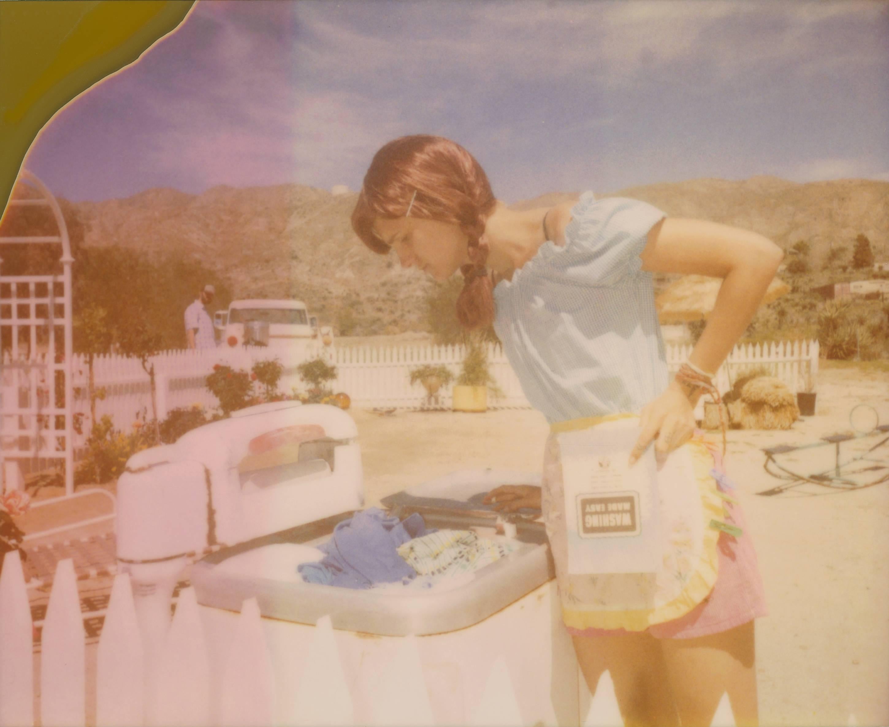 Stefanie Schneider Figurative Photograph - Washing made easy - The Girl behind the White Picket Fence