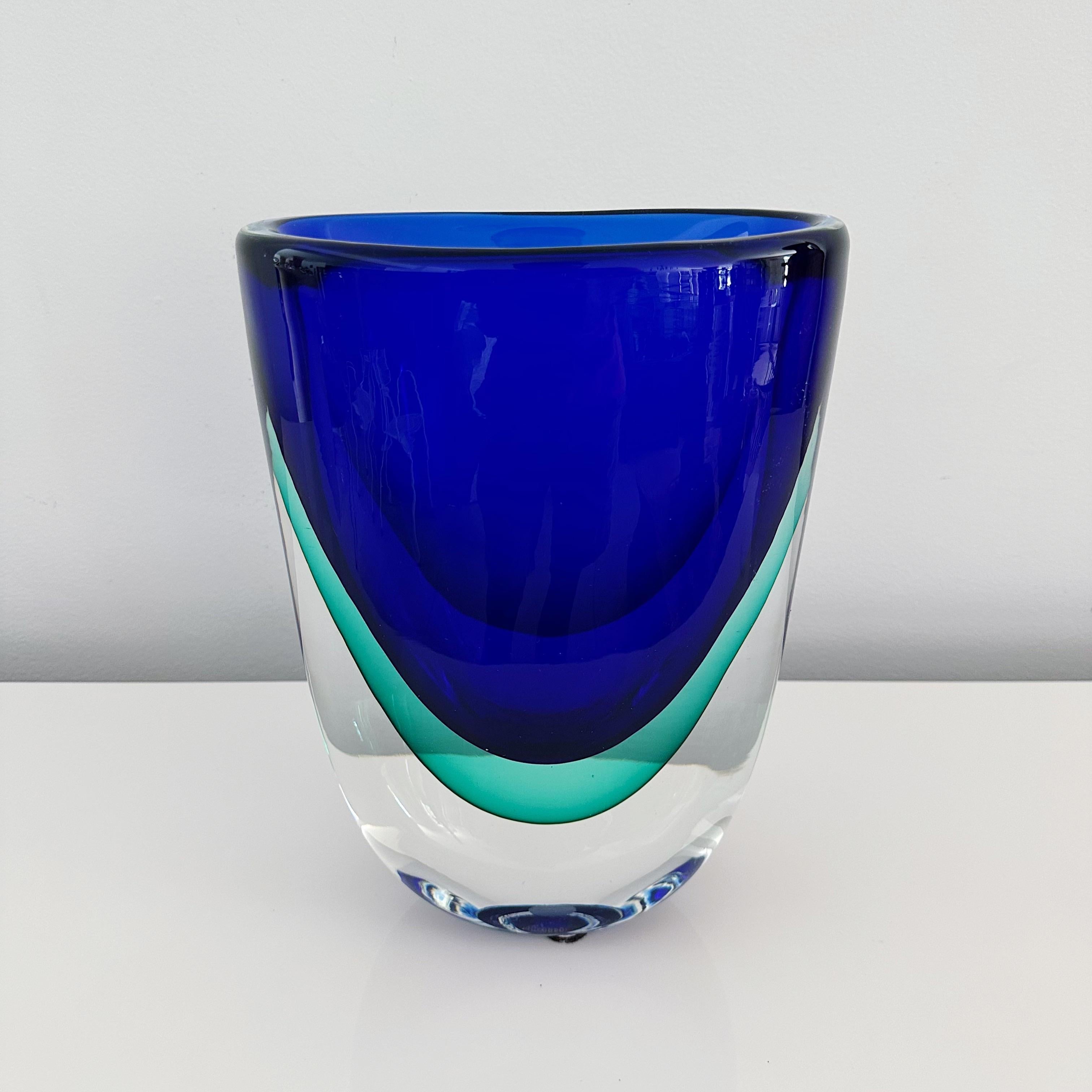 This rather large Murano vase, crafted in 2001, bears the signature of the master glass maker Stefano Toso on its underside. Showcasing the sommerso technique, with hues of cobalt blue, aqua blue, and clear glass. This particular piece is
