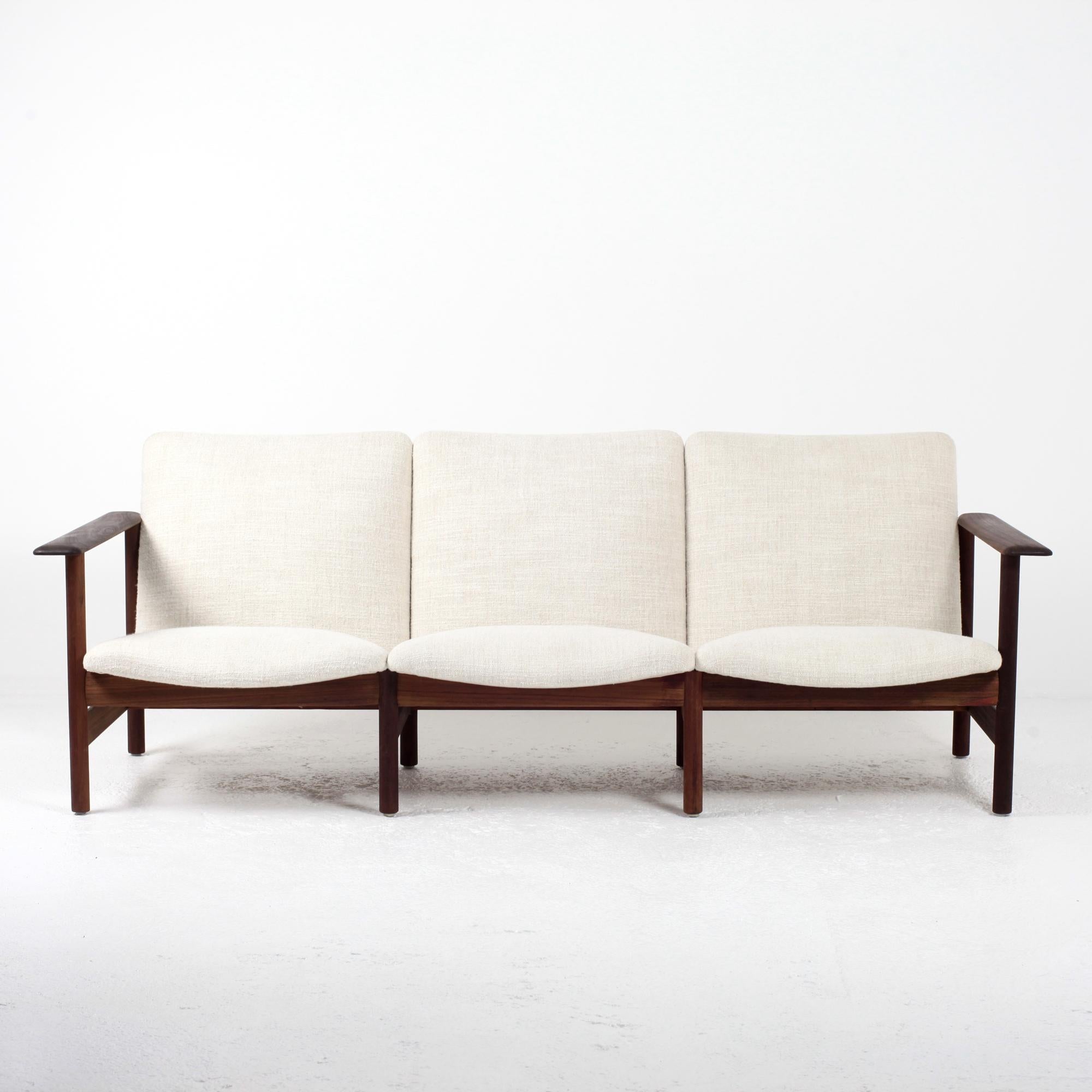 An extraordinary midcentury sofa from the 1960s manufactured by Sièges Steiner. With a solid wood frame, the sofa has been professionally reupholstered in a new very soft cream/beige fabric from the house of Pierre Frey. This modern vintage sofa is