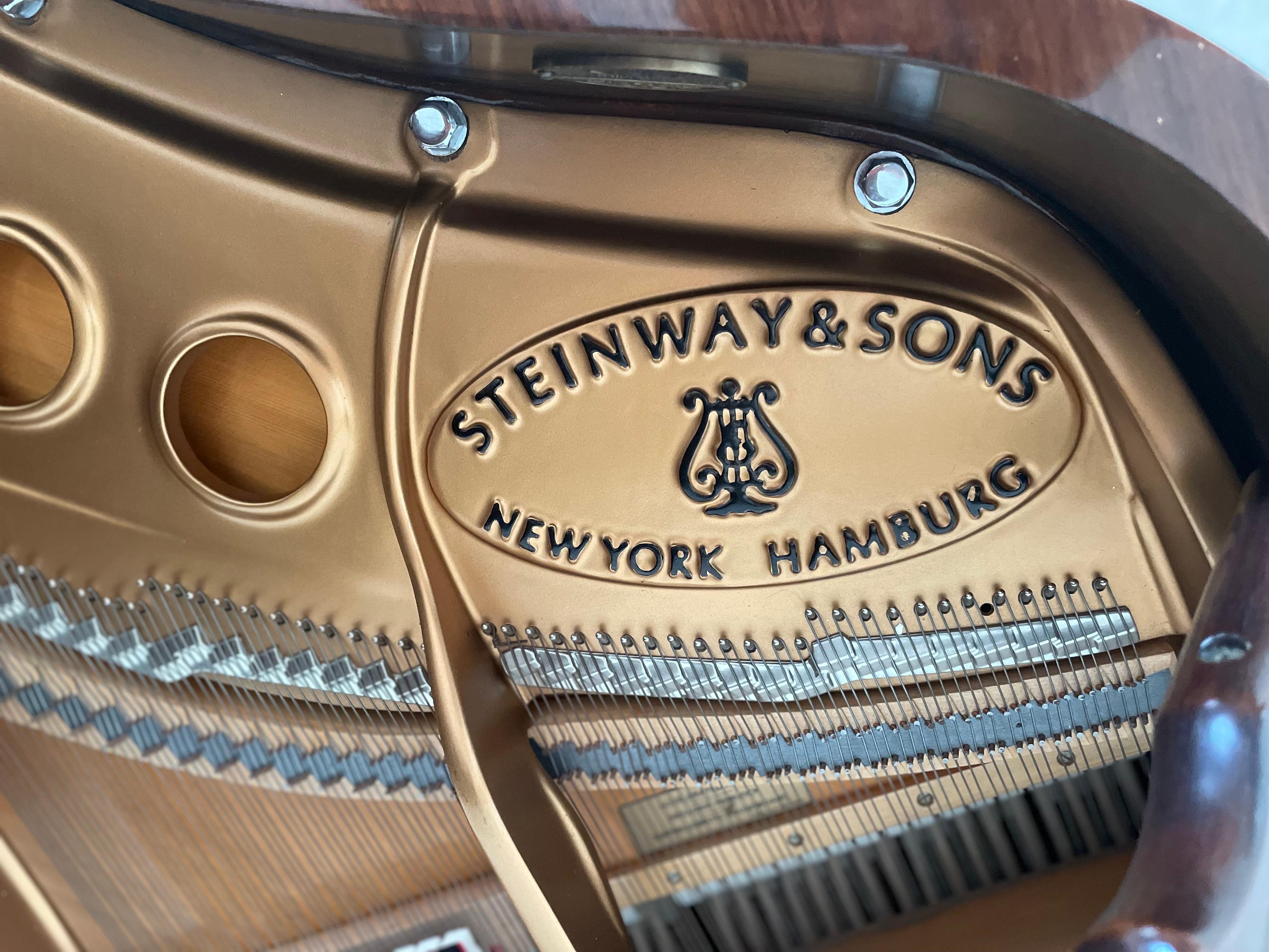 A Steinway & Sons Rosewood Baby Grand Piano
Model M Baby Grand Piano, manufacture completed in 1997
the harp-form case over tapering legs set on casters, above a three-pedal action, now with mechanical player mechanism
Model no. 539028
length 5