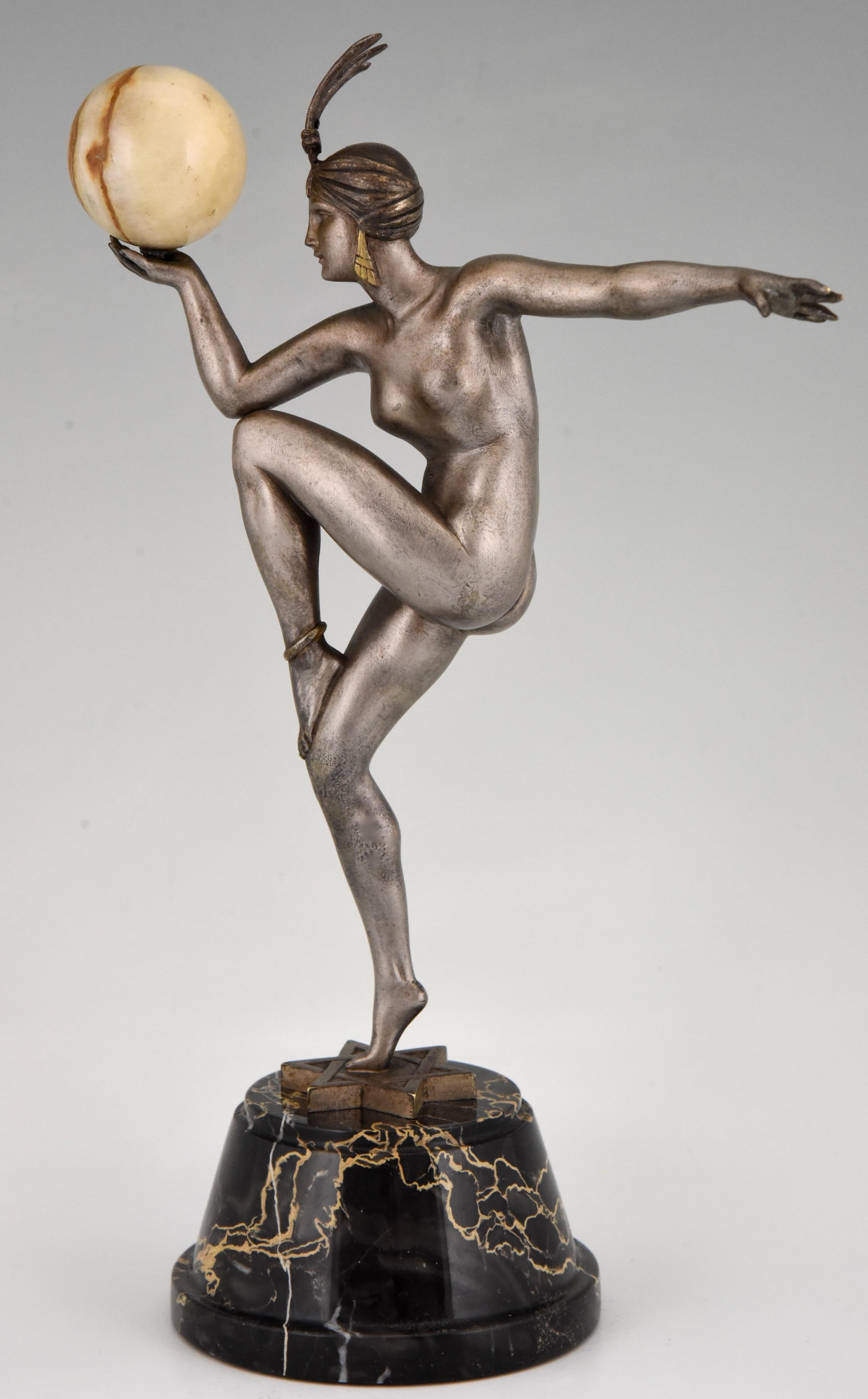 Stella, hard to find Art Deco bronze sculpture of a nude dancer with ball
by Maurice Guiraud Rivière with founders signature Etling Paris.
The dancer has the original silver patina and stands on a bronze star. She is holding a marble ball. The