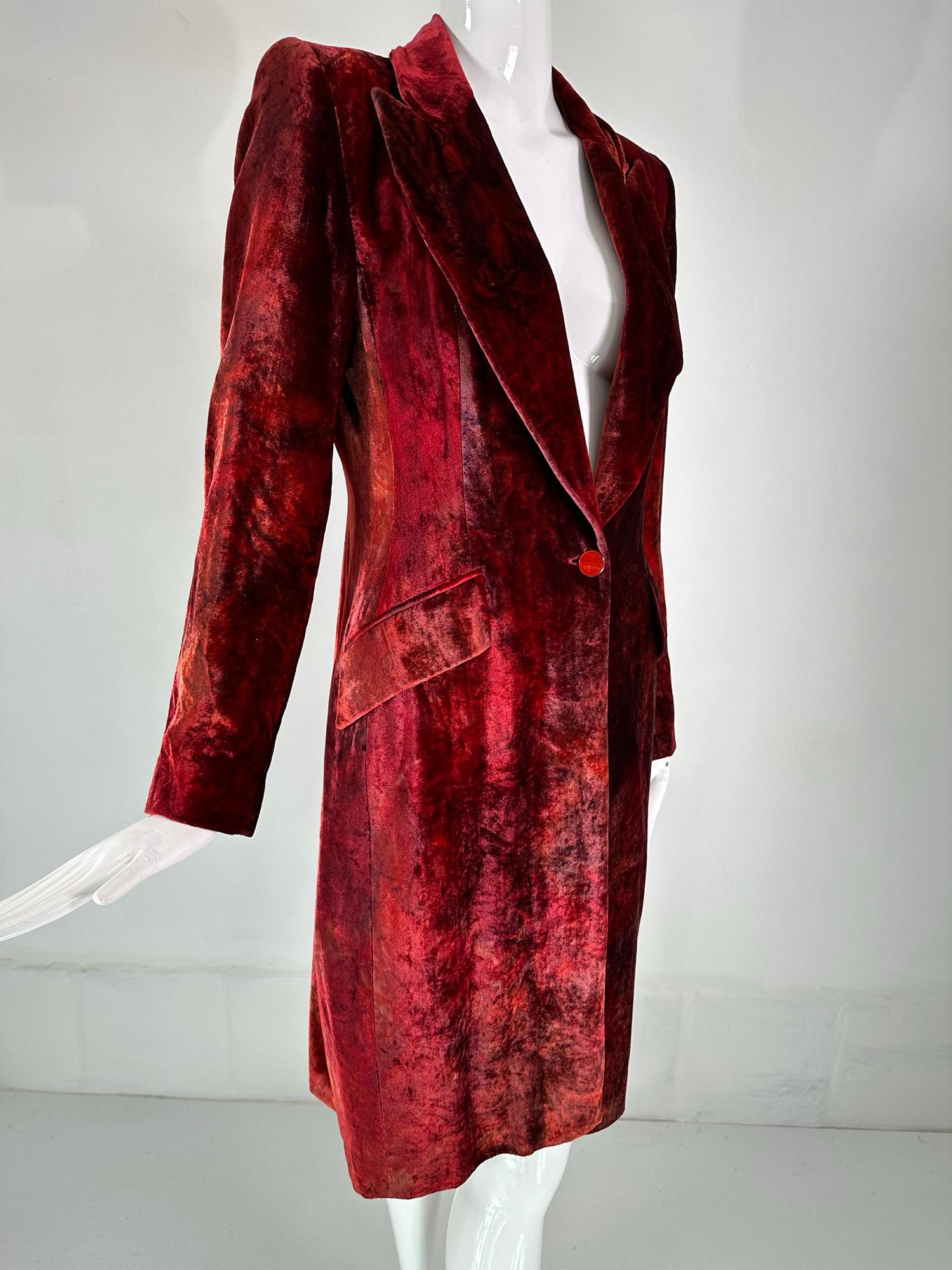 Stella Cadante Paris custom dyed velvet princess style coat. Narrow notched lapel coat closes at the waist front with a single red button, there are two angled hip flap non working  pockets at either side. Fitted through the waist. Long sleeves have