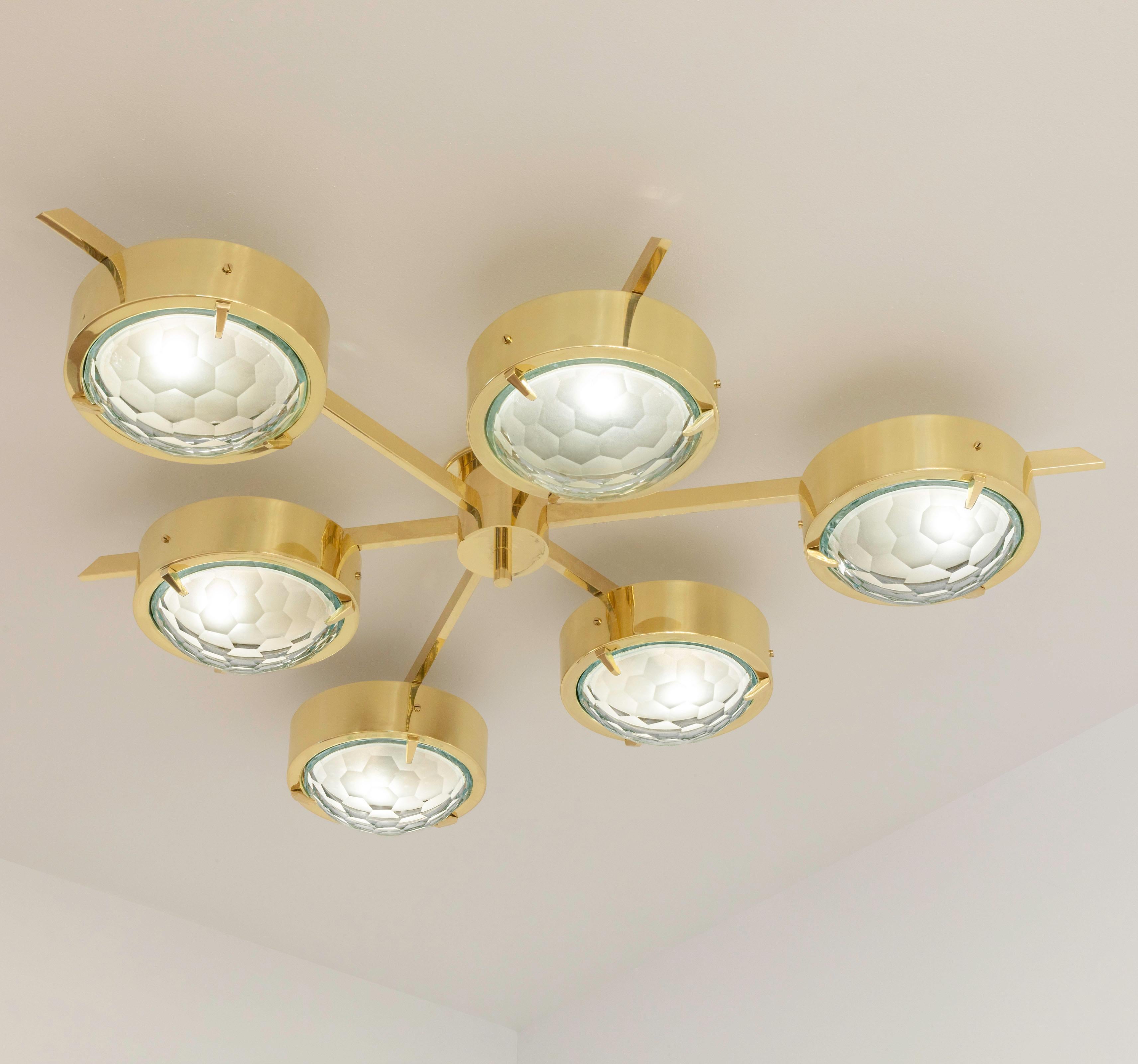 The Stella ceiling light features six shades hand faceted from thick starphire glass, balanced on a star shaped brass frame. Shown as a flush mount in polished brass.

Customization options:
Each fixture is hand crafted in Italy and can be