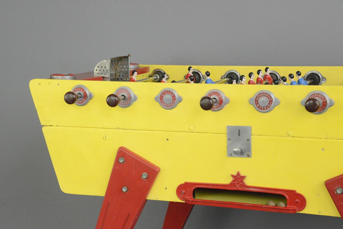 Stella champion babyfoot fooseball table, circa 1940s

- Cast steel players
- Original aluminium ash trays
- Pine body and legs with original yellow and red paint
- Original cork balls x2
- Made by Stella
- French, late 1940s
- Measures: