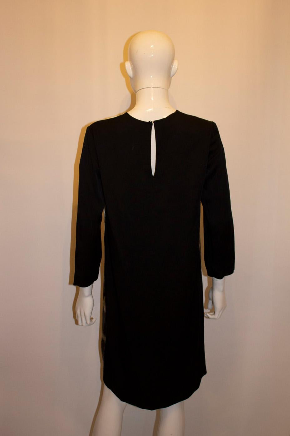 A chic shift dress by Stella Mc Cartney . In a silk mix the dress has an attractive tree print on the front , and a button opening at the back . It is unlined. Size 40 Measurements. Bust up to 38'', length 37''