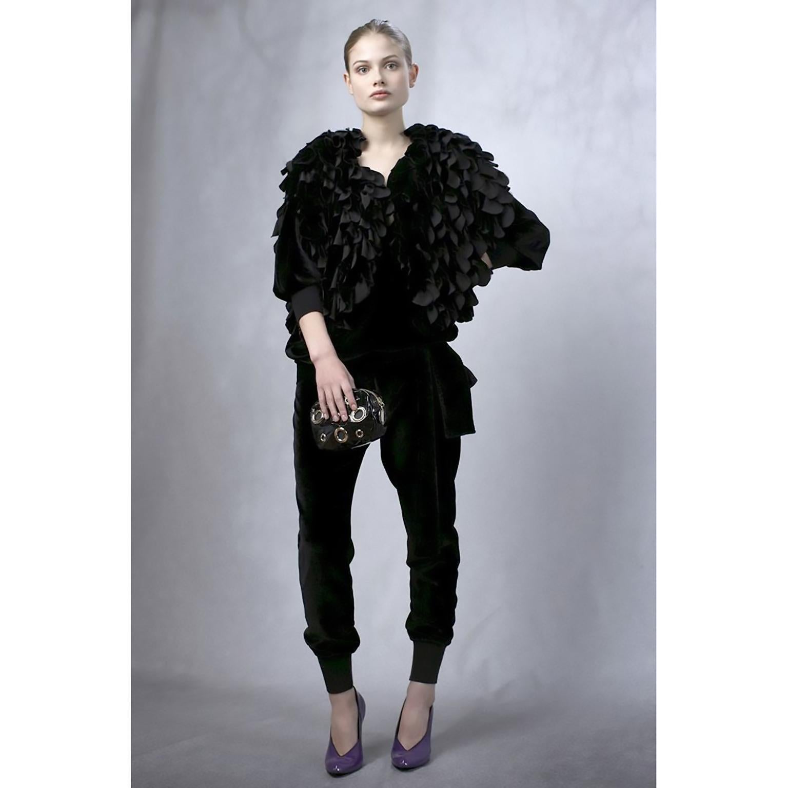 This incredible black evening stole was designed by Stella McCartney for her 2009 pre-fall collection. The wrap has ruffled layers of black silk organza and is beautifully made with silk lining and a black grosgrain ribbon tie.  Made in Italy, this