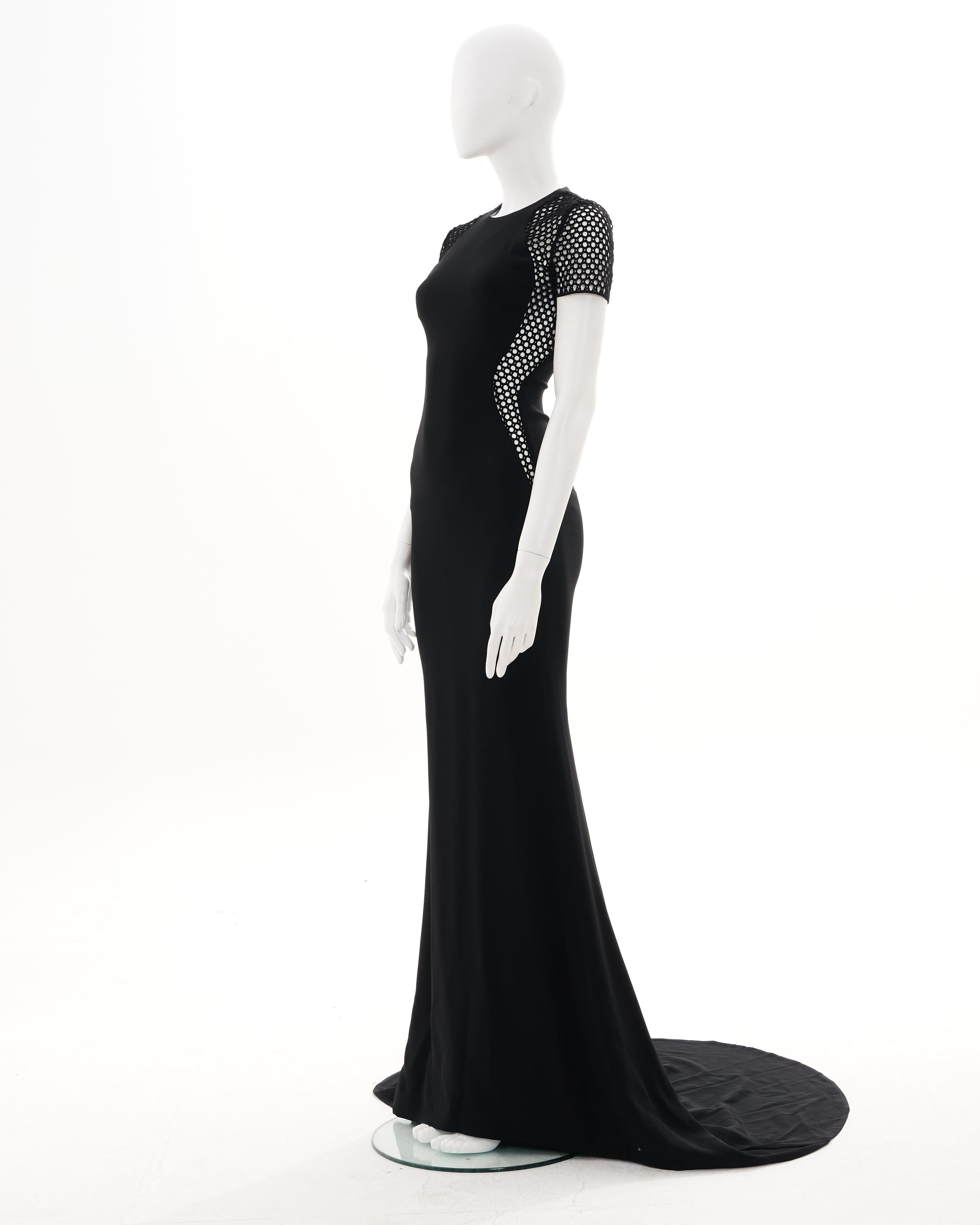 - Designed by Stella McCartney
- Sold by Skof.Archive
- 2014 Collection
- Black silk evening dress with train
- Made in Italy
- Materials: Rayon, Polyester and Acetate
- Size FR 34 - EN 38 - UK 6 - US 2 (EU)
- Short sleeves with mesh inserts
-