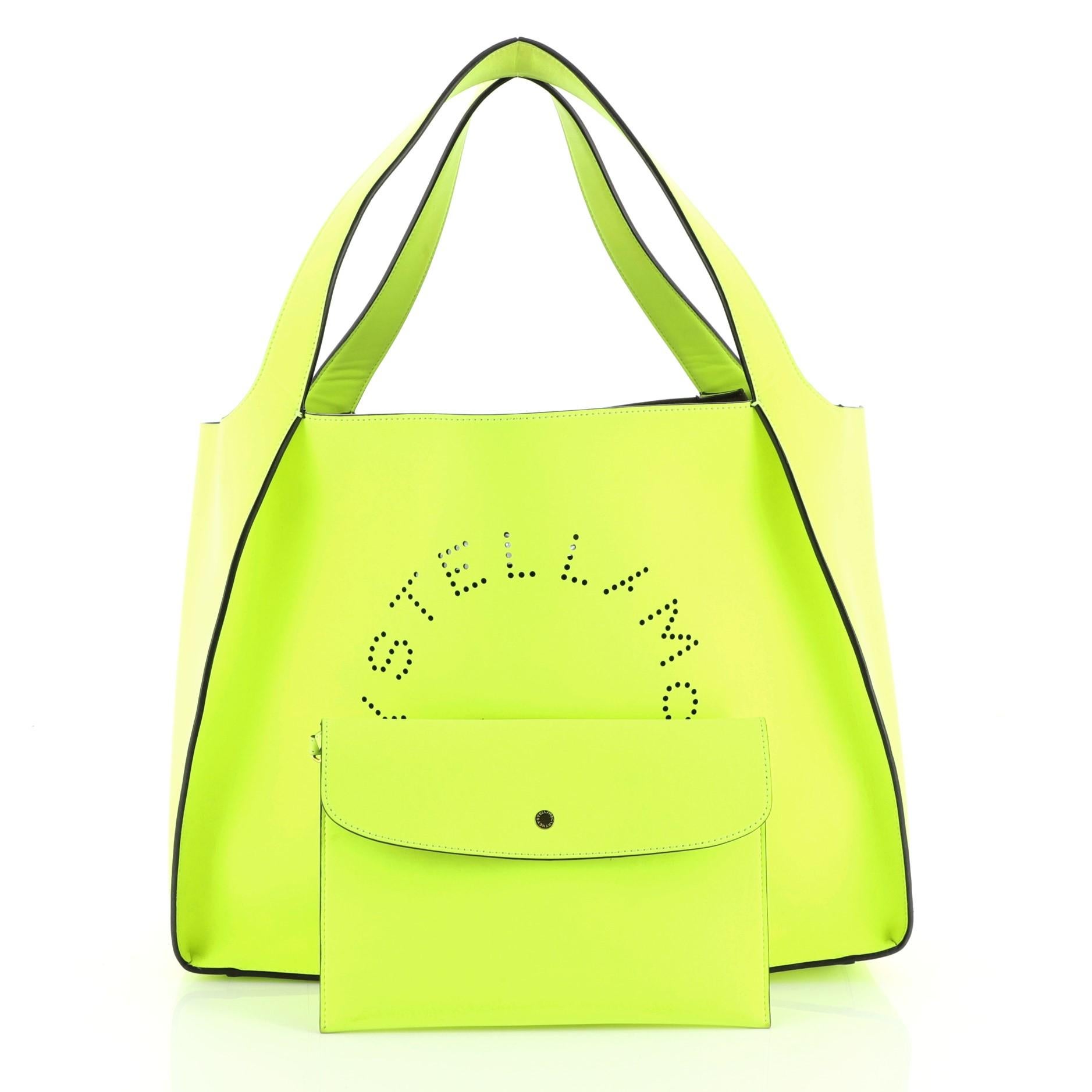 This Stella McCartney Alter Tote Perforated Faux Leather East West, crafted in green perforated faux leather, features dual flat handles, perforated logo at front, and gold-tone hardware. Its wide open top showcases a brown microfiber interior.