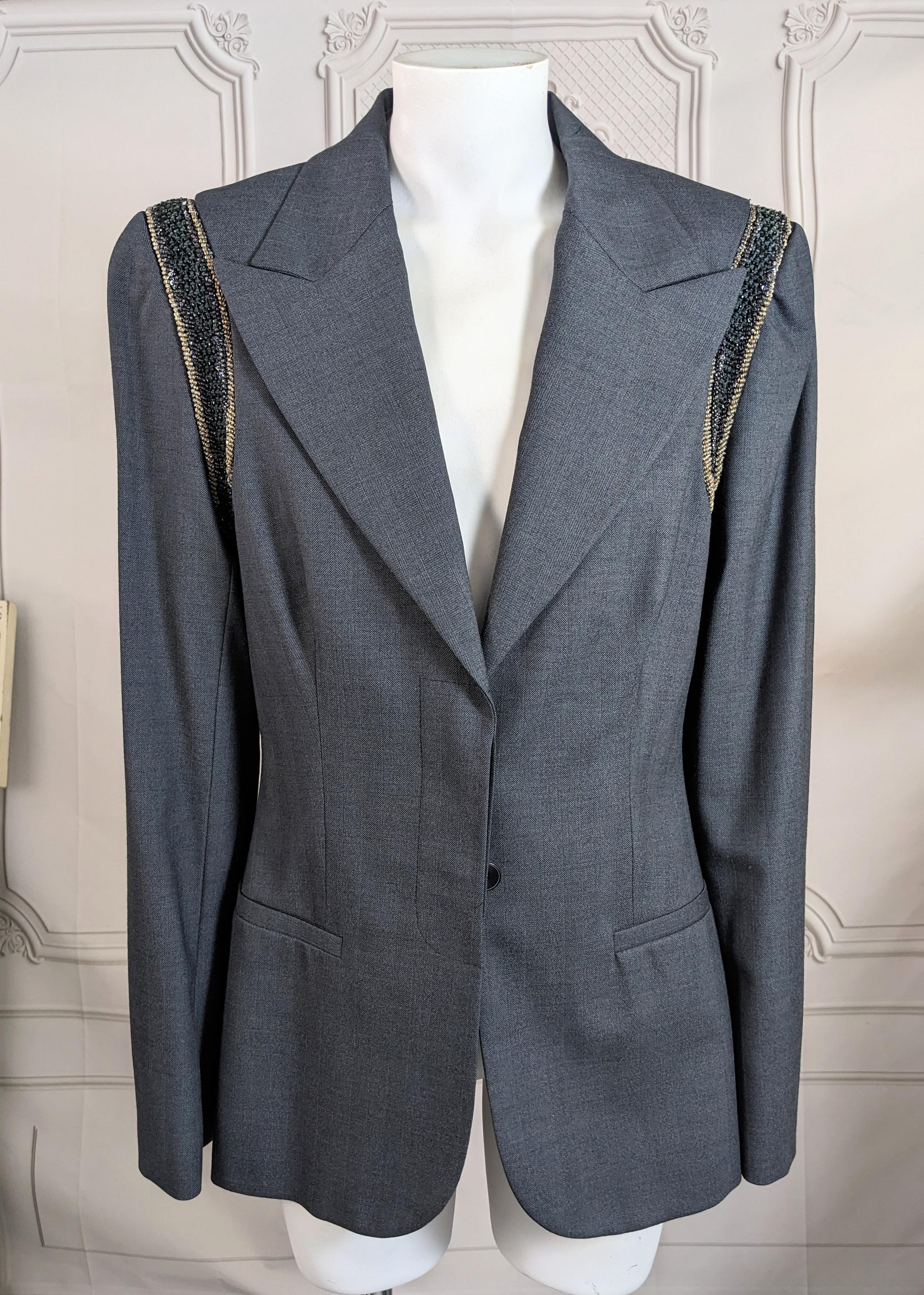 Stella McCartney Bead and Bullion Encrusted Blazer. Beautifully tailored in a crisp deep gray wool blend with peak lapels and hidden fly front button closure. The strong shoulders are trimmed with finely beaded jet and gilt bullion thread. Size 42,