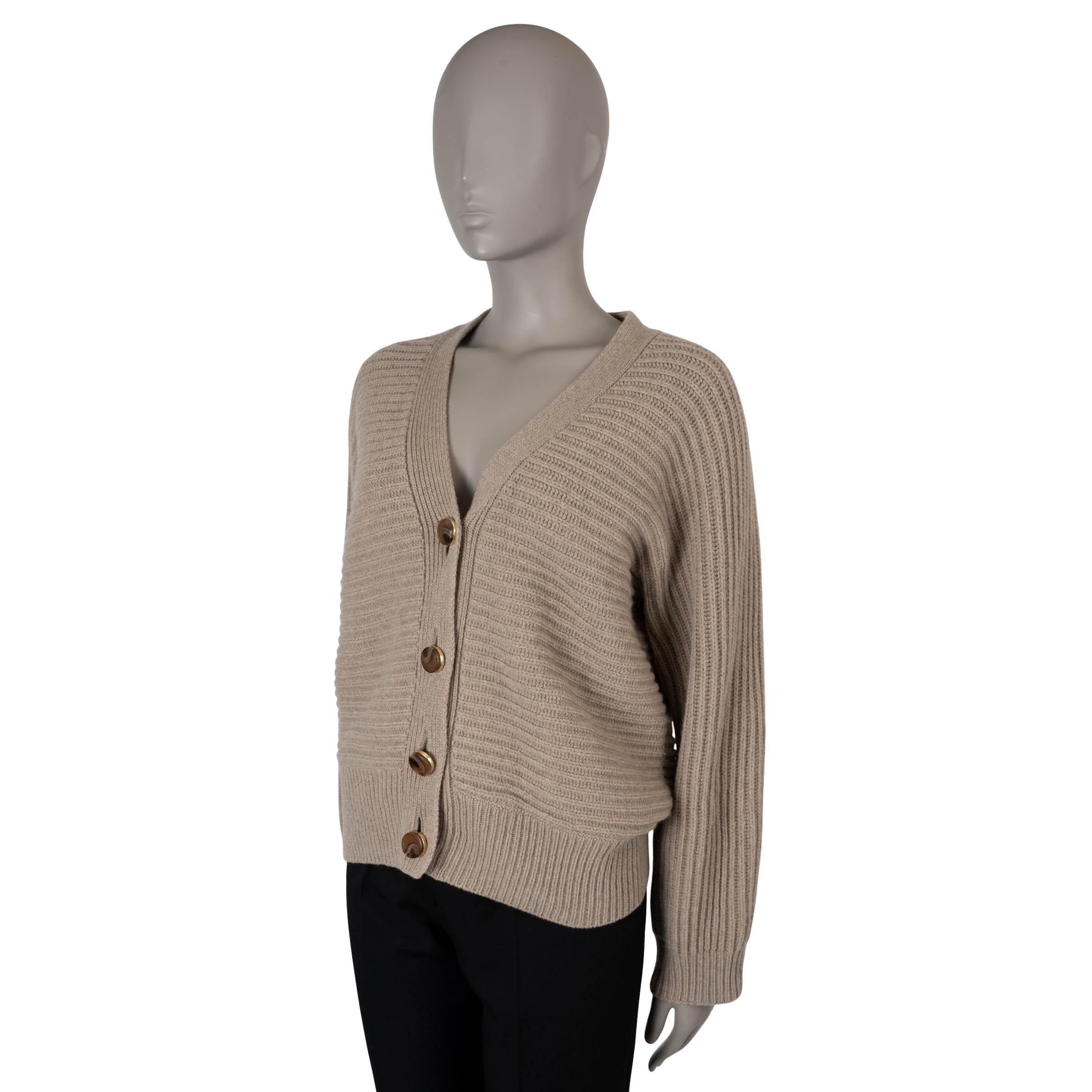 This 100% authentic Stella McCartney cardigan is crafted from a luxurious blend of oat beige horizontal rib-knit cashmere (95%) and wool (5%). It features a boxy, oversized silhouette with rib-knit trims, offering a cozy and chic look. The cardigan