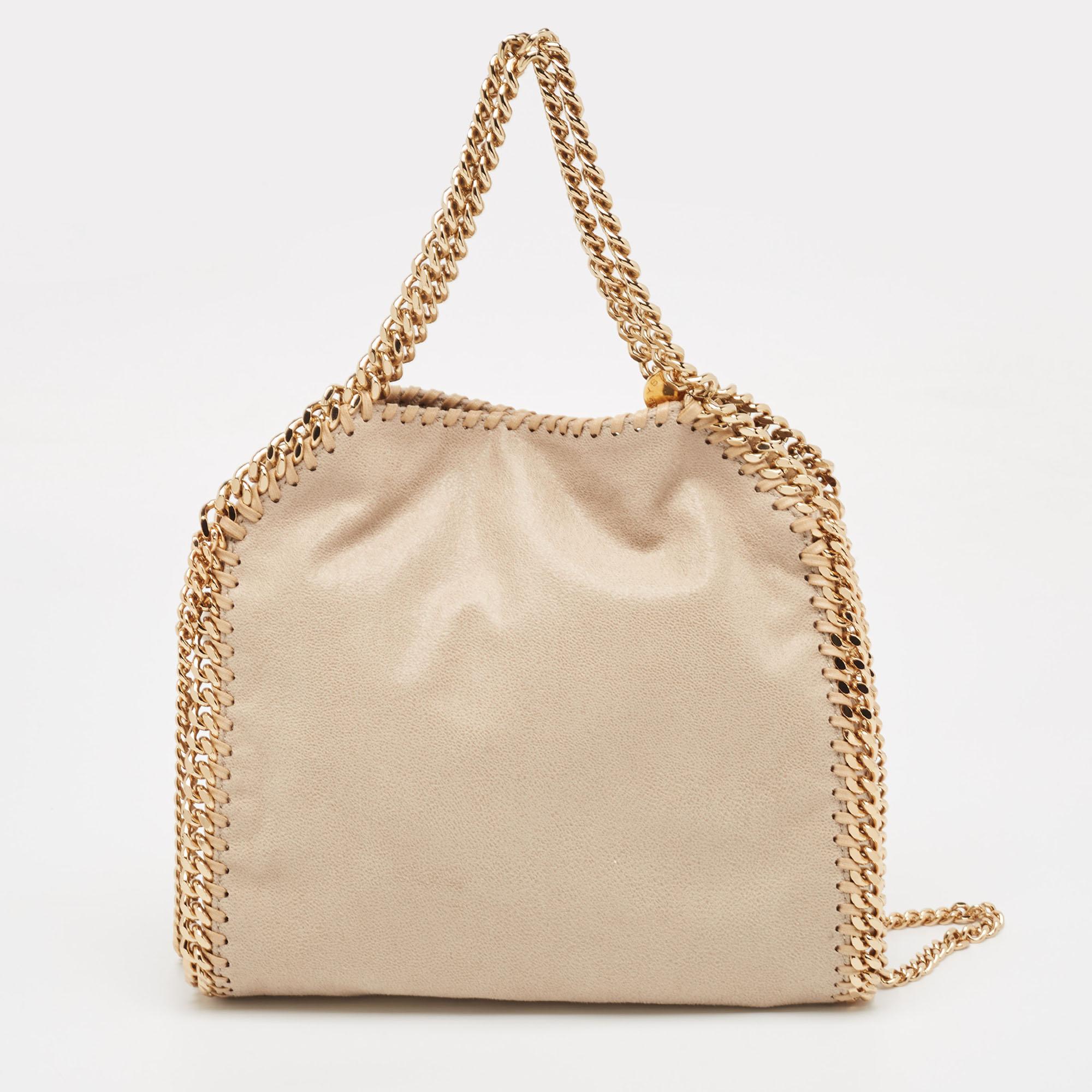 Created from high-quality materials, this Stella McCartney Falabella tote is enriched with functional and classic elements. It can be carried around conveniently, and its interior is perfectly sized to keep your belongings with ease.

Includes: Info