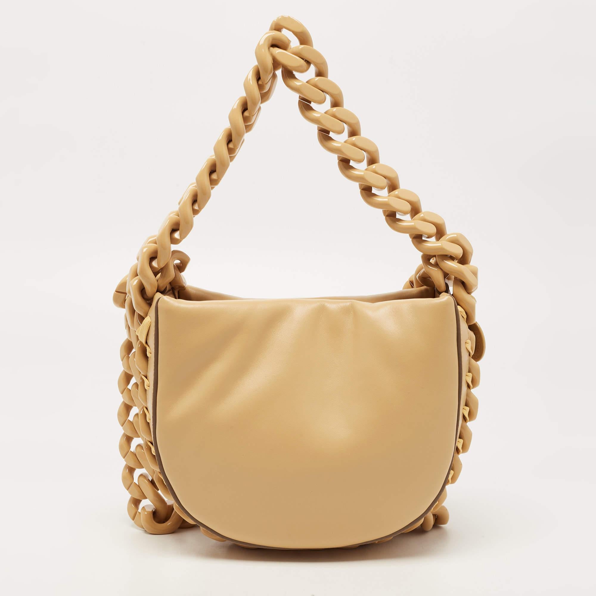 The Stella McCartney Frayme Bag is a stylish and versatile accessory designed for the fashion-forward individual. With its crescent silhouette and high-quality faux leather construction, this bag effortlessly combines luxury and sustainability.