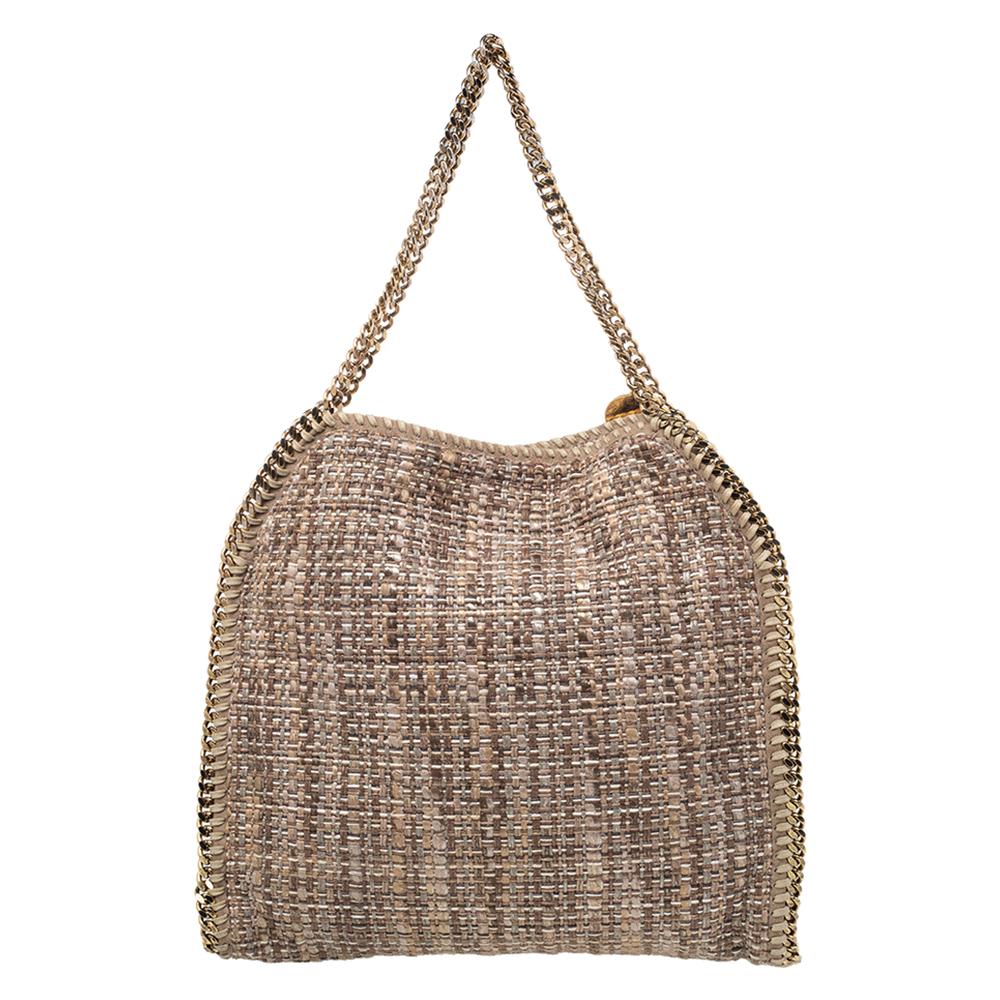 This Falabella tote from Stella McCartney will make the dream of countless women come true. Crafted from boucle tweed, it is durable and stylish. While the chain detailing elevate its beauty, the fabric-lined interior will dutifully hold all your