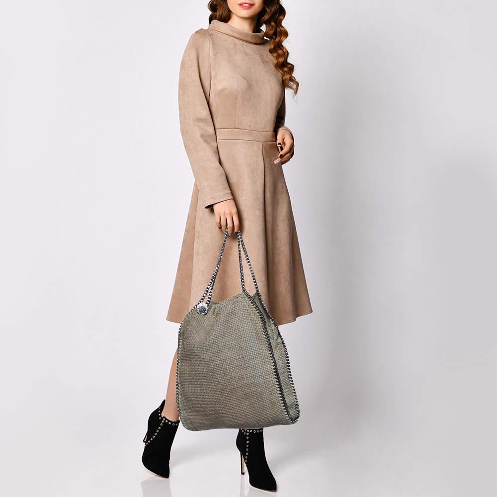 This Falabella bag from Stella McCartney is a beauty. Crafted from tweed it is durable and stylish. While the chain detailing elevates its beauty the lined interior will dutifully hold all your daily essentials.