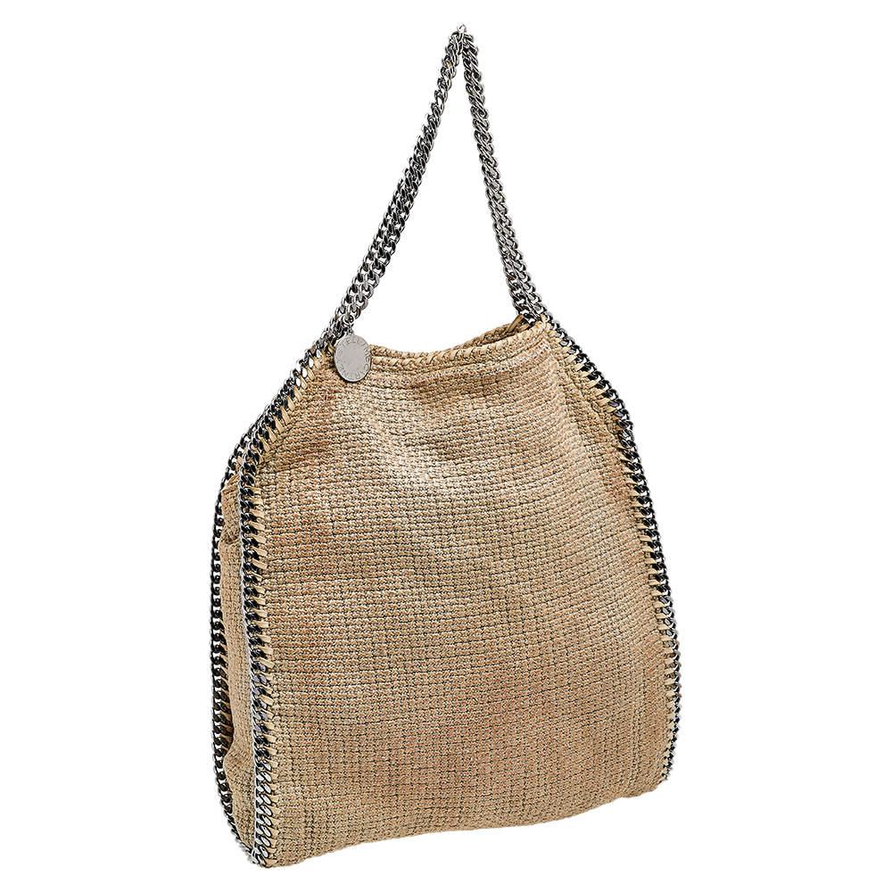 This Falabella bag from Stella McCartney is a beauty. Crafted from tweed, it is durable and stylish. While the chain detailing elevates its beauty, the lined interior will dutifully hold all your daily essentials.

Includes: Pouch