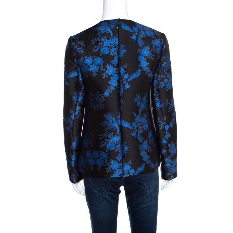 This one is an elegant piece from the house of Stella McCartney. Fabulously crafted, this gorgeous top is adorned with a blue and black floral jacquard pattern all over. Channel a chic, feminine vibe by styling it with a solid coloured skirt and