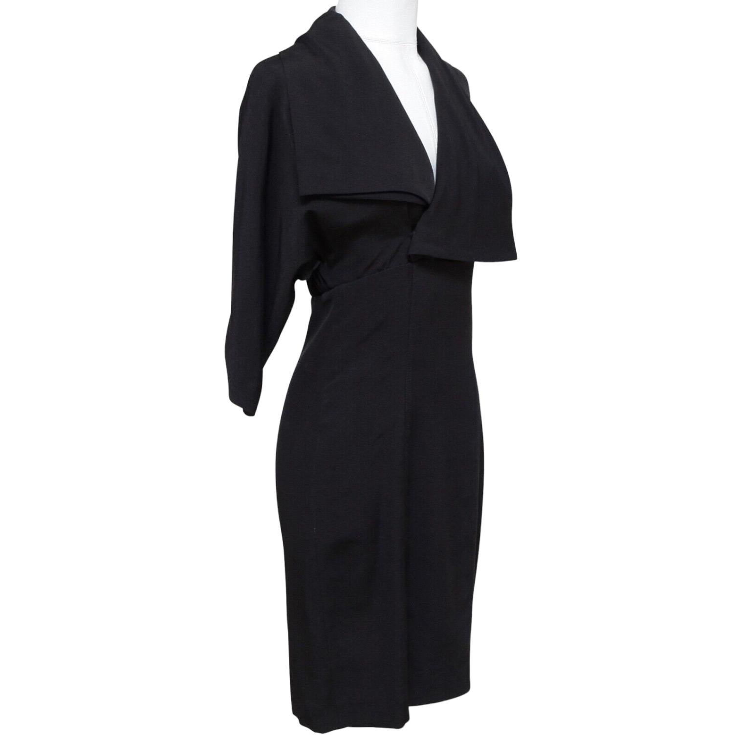 GUARANTEED AUTHENTIC STELLA MCCARTNEY STUNNING BLACK WOOL SILK DRESS



Design:
- Black blouson style wool silk blend dress.
- Straight silhouette.
- Elasticized at waist with covered front button.
- Concealed side zipper.
- 3/4 dolman sleeve with