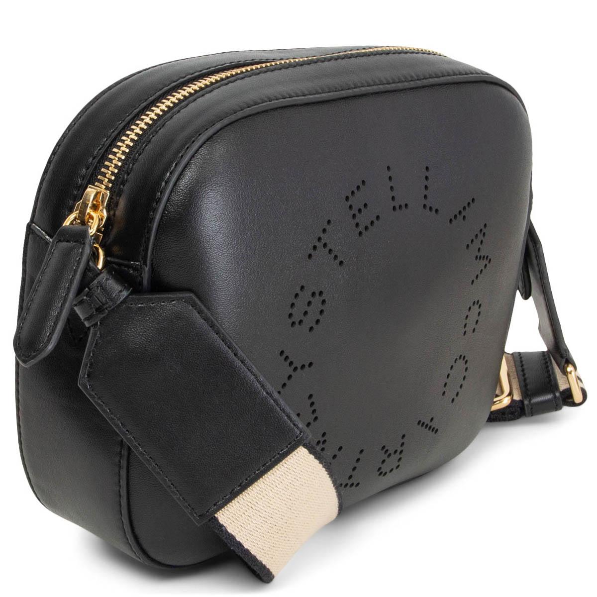 100% authentic Stella McCartney Logo Strap Shoulder Camera Bag crafted from black artificial leather that features a detachable and adjustable shoulder strap, a top zip fastening, decorative perforations and a front centre logo stamp. Lined in ochre