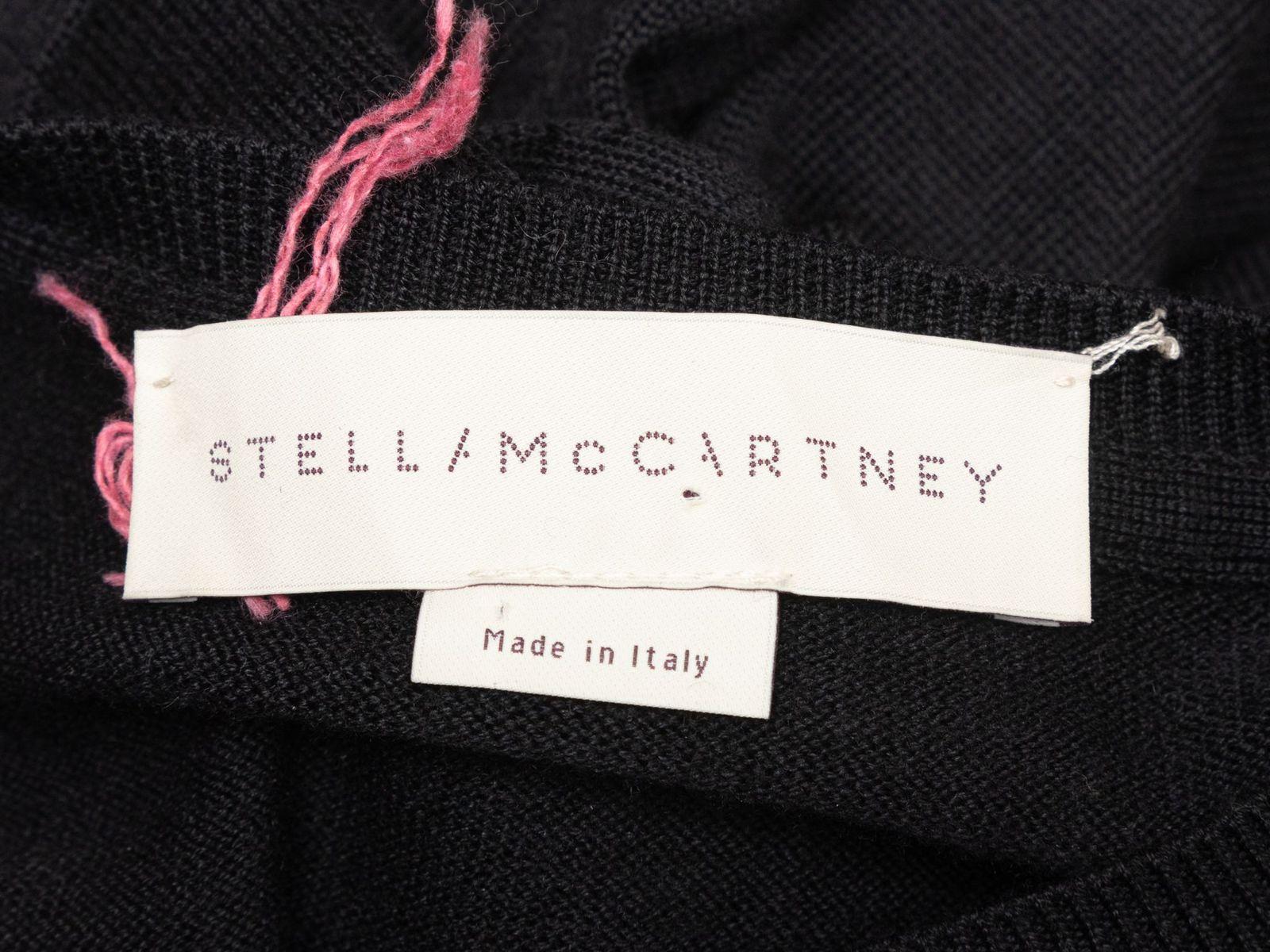 Product Details: Black, white, and red lipstick motif intarsia patterned virgin wool sweater by Stella McCartney. Crew neck. Long sleeves. Designer size 36. 36