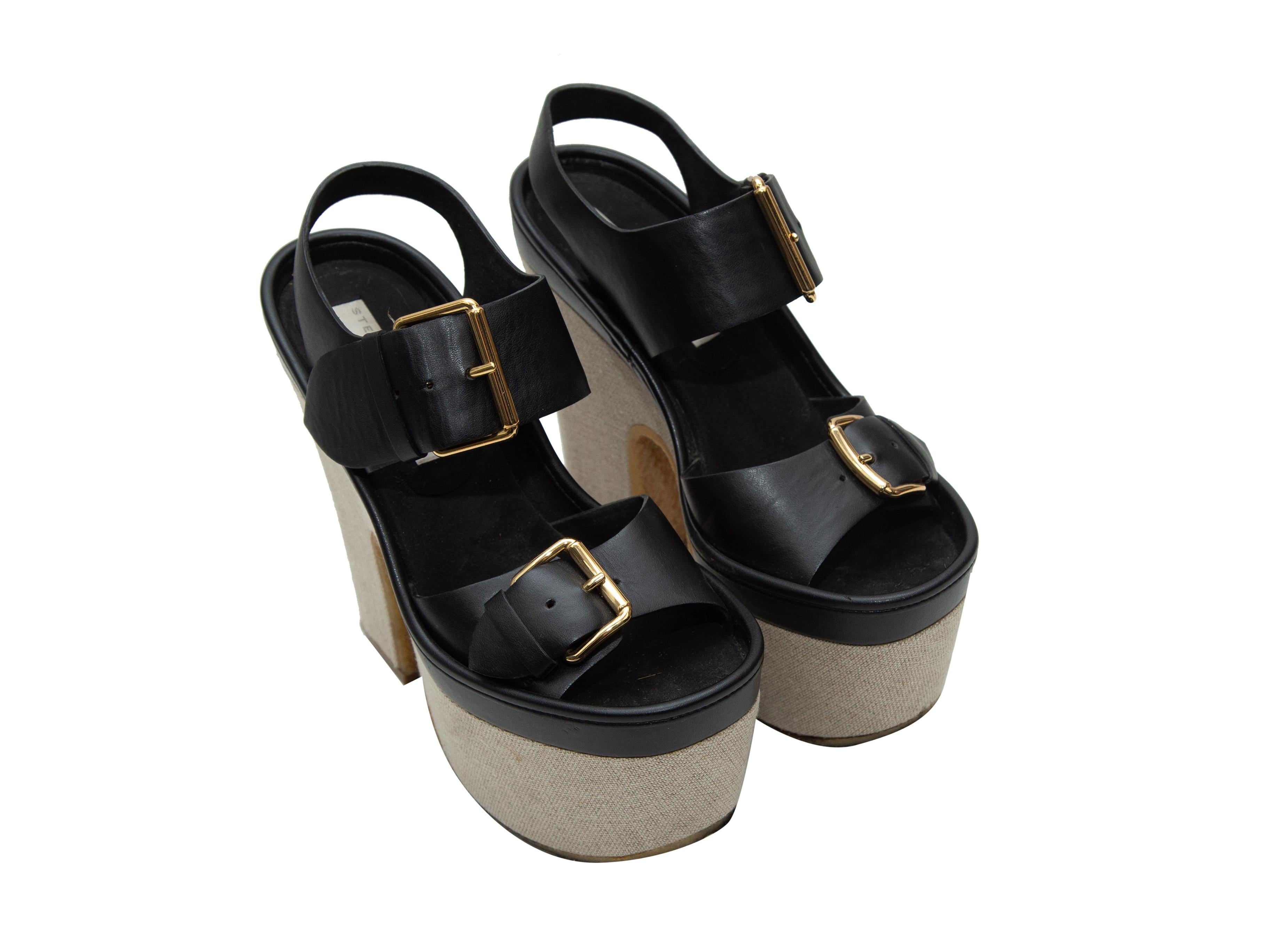 Product details: Black and beige platform sandals by Stella McCartney. Rubber soles. Gold-tone buckle closures at tops. 5.5