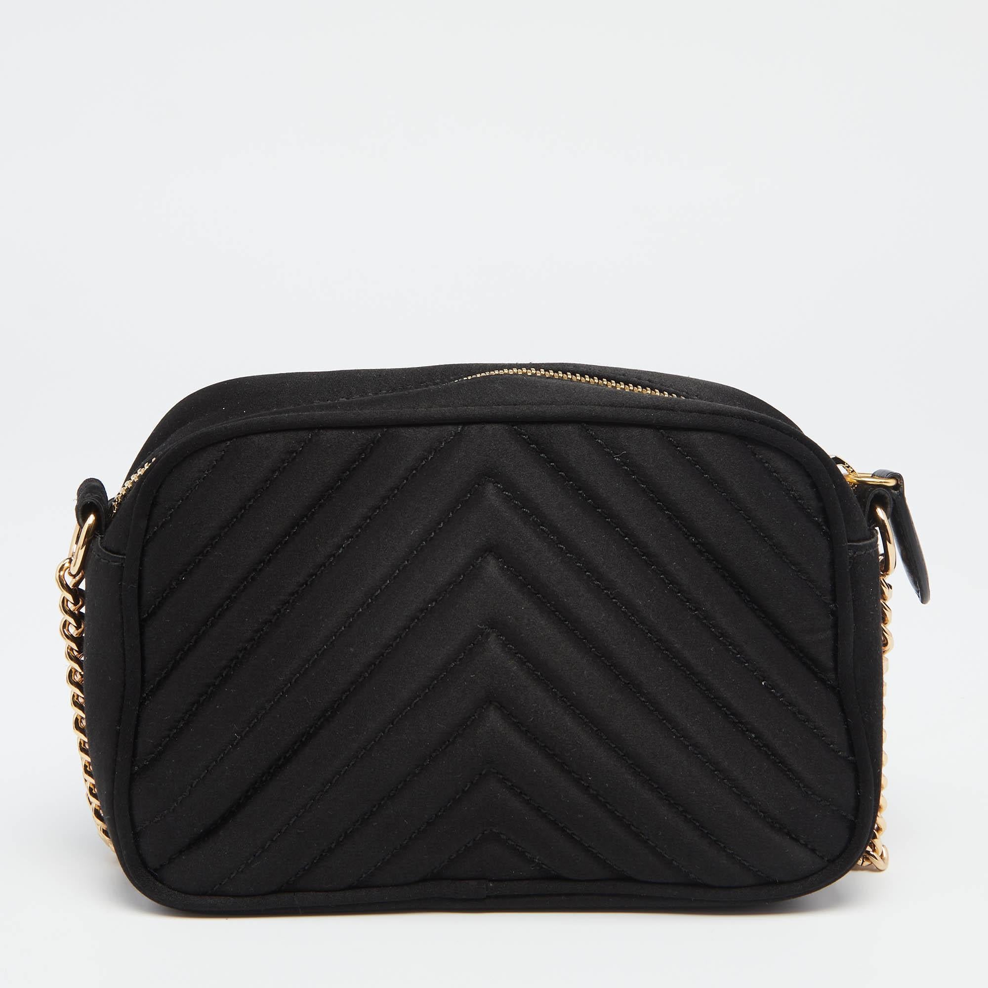 Coming from the House of Stella McCartney, this Stella Star crossbody bag will help your style sparkle! It is made from black quilted satin and comes with a gold-toned star motif embellishment on the front elevated by chains. It has an