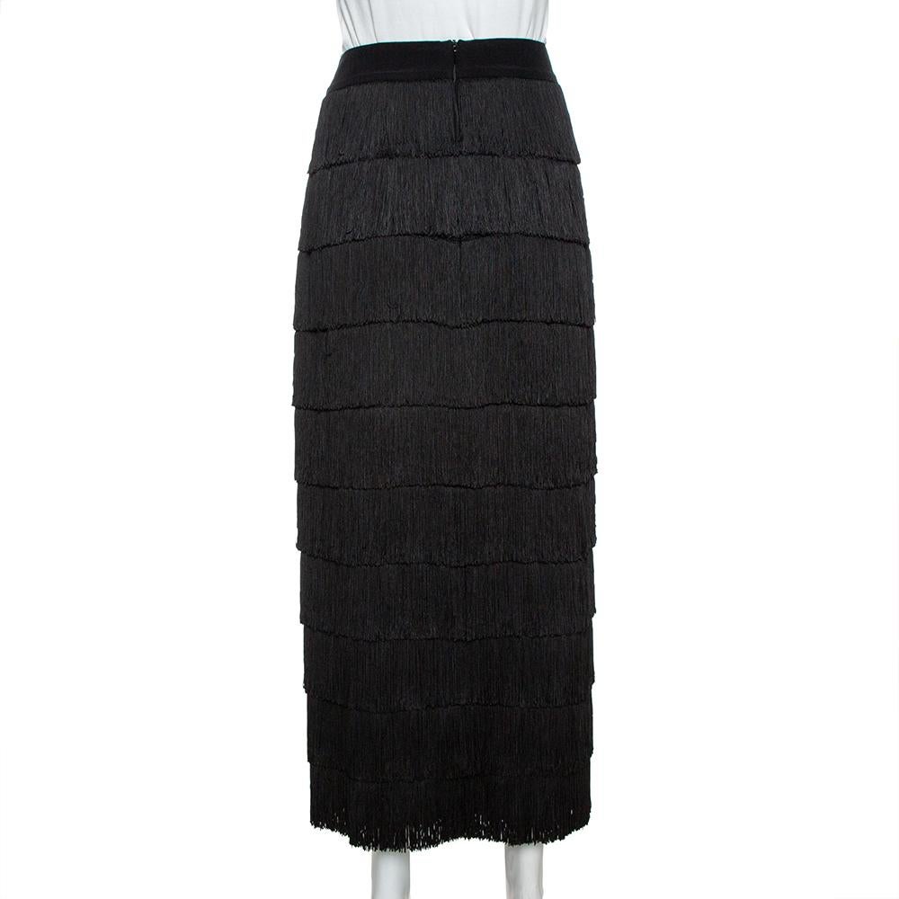 Feminine aesthetics and comfortable style pretty much define this skirt from the house of Stella McCartney. Crafted in silk, it features fringe detailing all over in a tiered style. Falling to a knee-length, you can style it with a solid top and