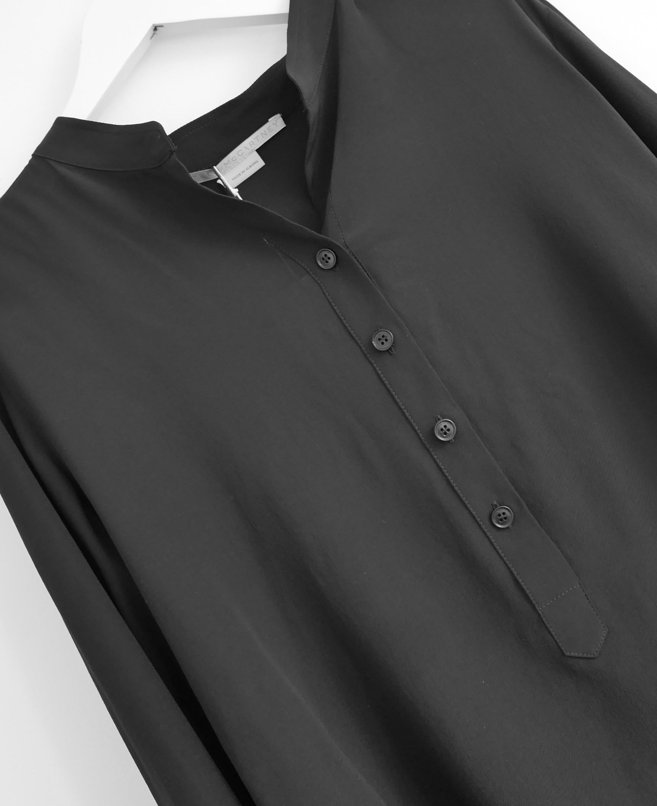 Classic, timeless Stella McCartney black silk shirt. Bought for £595 and new with tag/spare buttons. Made from matte charcoal black silk, it has a very relaxed fit with open neck, half button front and curved hem. Size IT36/UK4 and will fit several