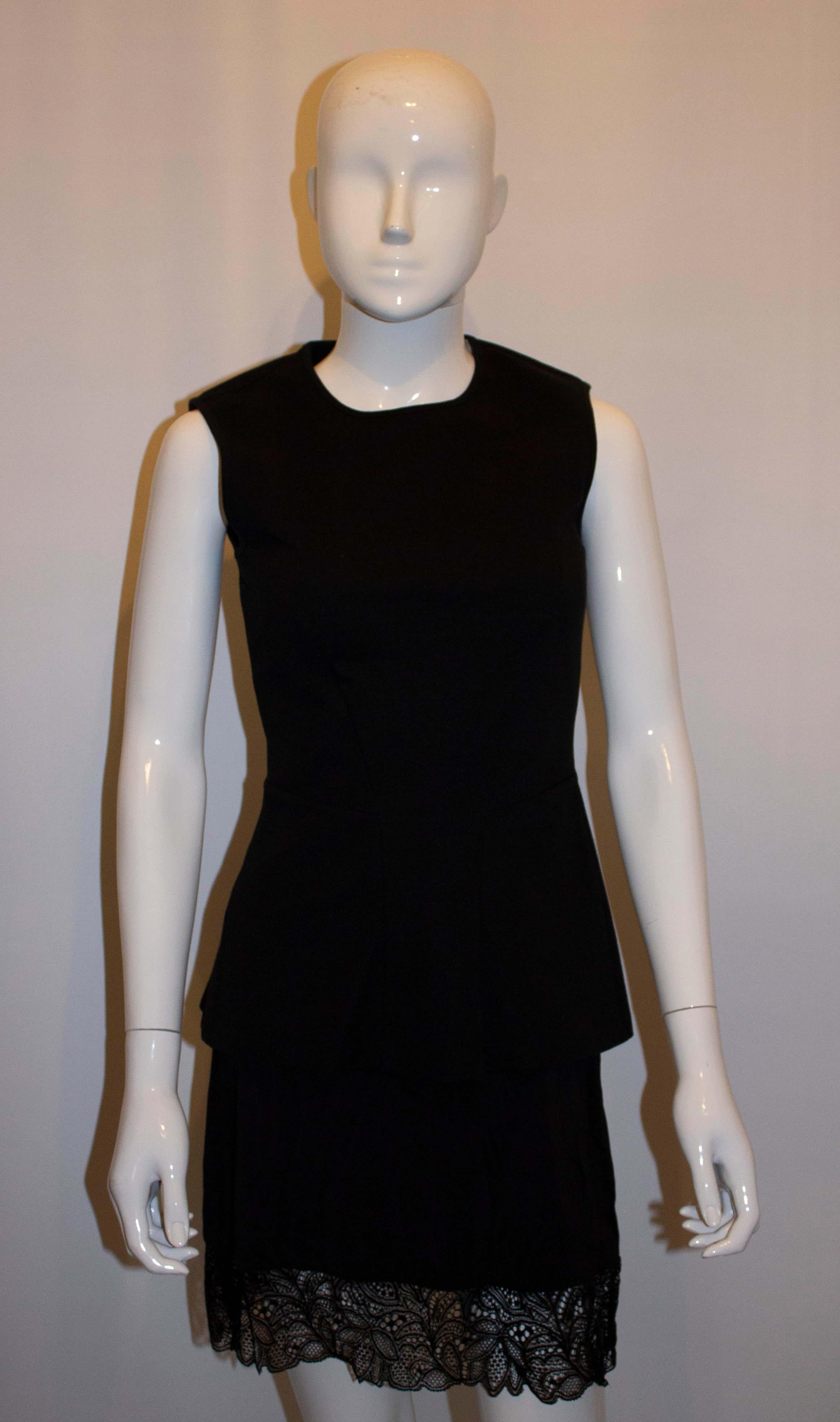 A chic black tailored shell top by Stella McCartney. In a cotton mix the top has a round neckline and central back zip. Size 42, Measurements: Bust 34'' . length 25''