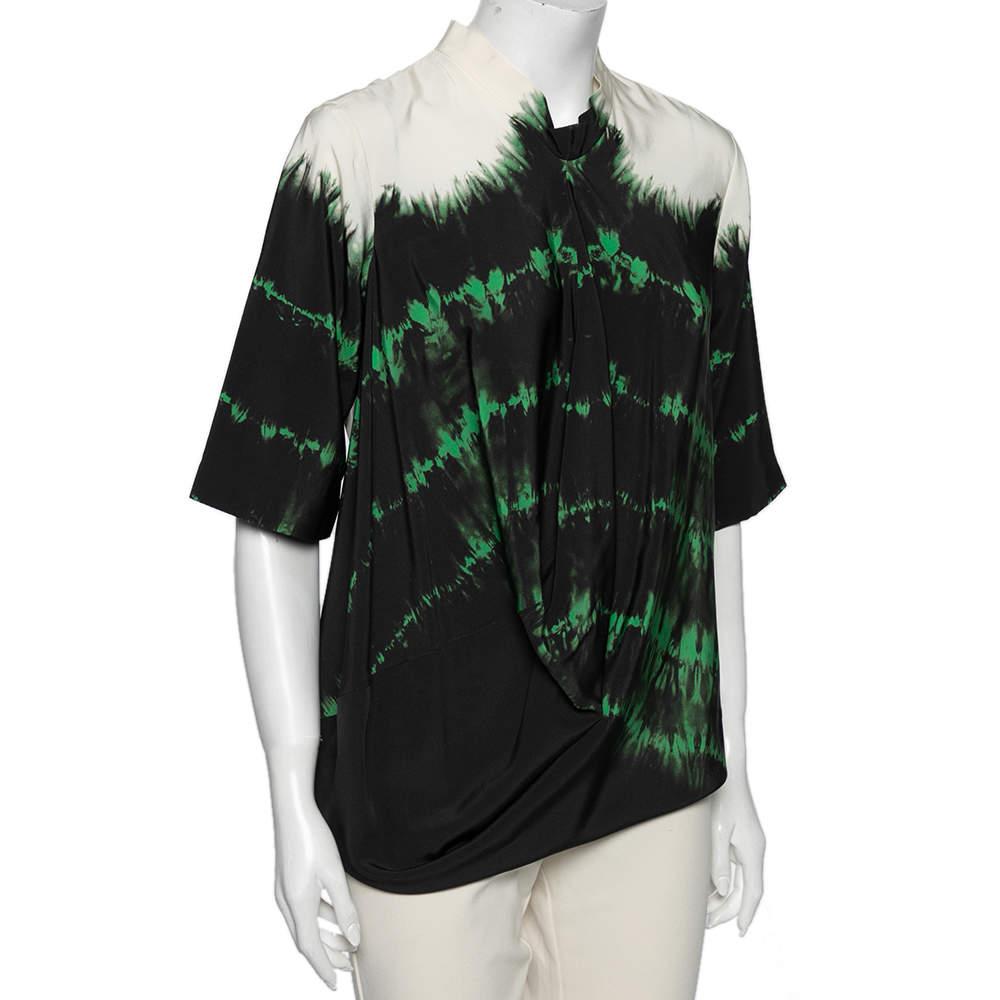 Upgrade your style quotient with this trendy tie-dye blouse from Stella McCartney. It is skillfully crafted from silk and has a gorgeous, asymmetrical draped front that adds a unique touch. It is the perfect day-to-night piece and is complete with a