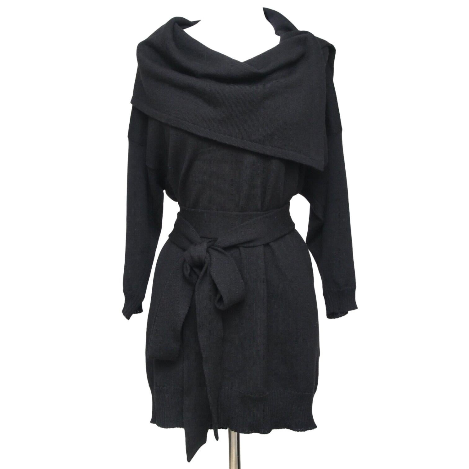 GUARANTEED AUTHENTIC STELLA MCCARTNEY BLACK WOOL TUNIC SWEATER
 Details:
 • Black knit style tunic with matching detachable belt, great easy fit.
 • Exaggerated cowl neck with large snaps which can be adjusted for style.
 • Ribbing at arms and hem.
