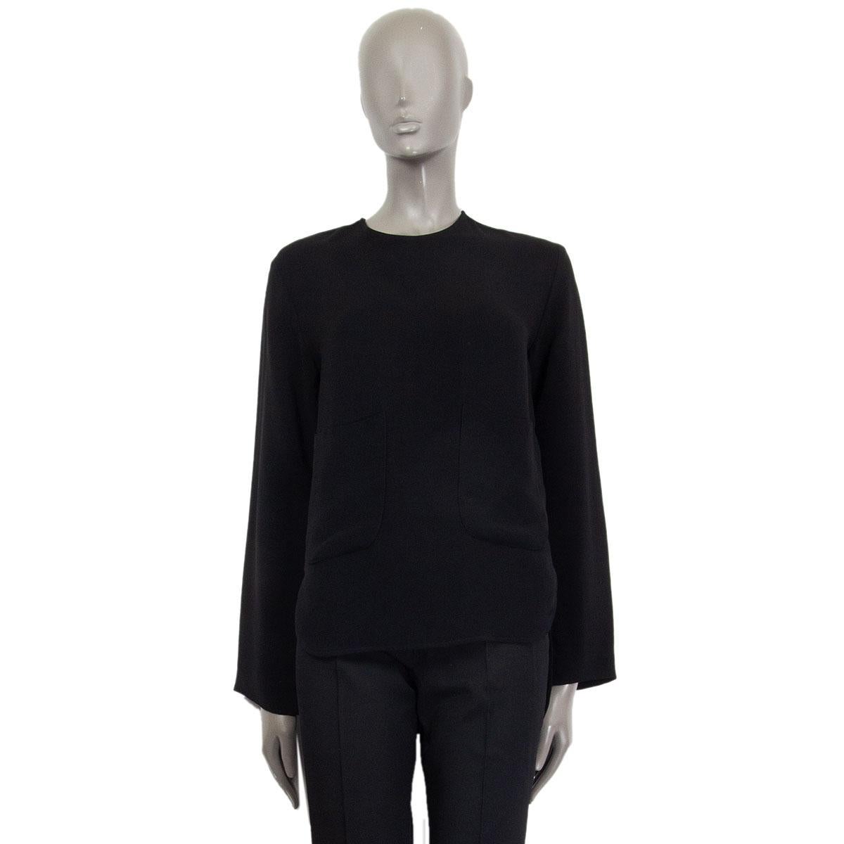 authentic Stella McCartney long-sleeve round-neck blouse in black viscose (79%) and acetate (21%). Features a longer back and two patch pockets at front. Opens with a zipper on the back. Has been worn and is in excellent condition. 

Tag Size