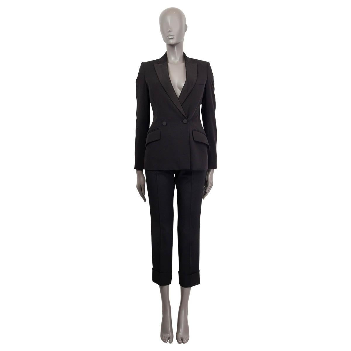 100% authentic Stella McCartney Peak Lapel Tuxedo Blazer in black wool (100%) and lined in viscose (100%). Collar and lapels are made of grosgrain fabric. Blazer closes with two buttons and features two flap pockets and one chest pocket at front.