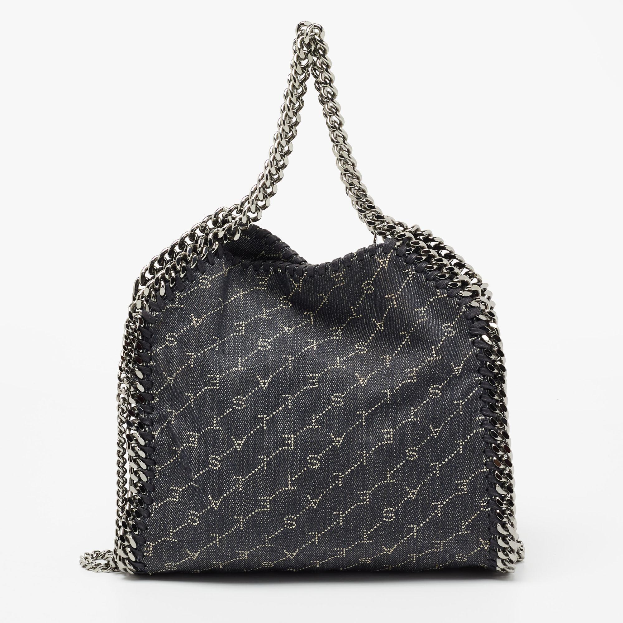 The chain whipstitch detailing beautifully outlines this Stella McCartney Falabella tote. Crafted from blue monogram denim, it is adorned with silver-tone accents, and the bag can be carried with dual chain handles. The fabric-lined interior of the