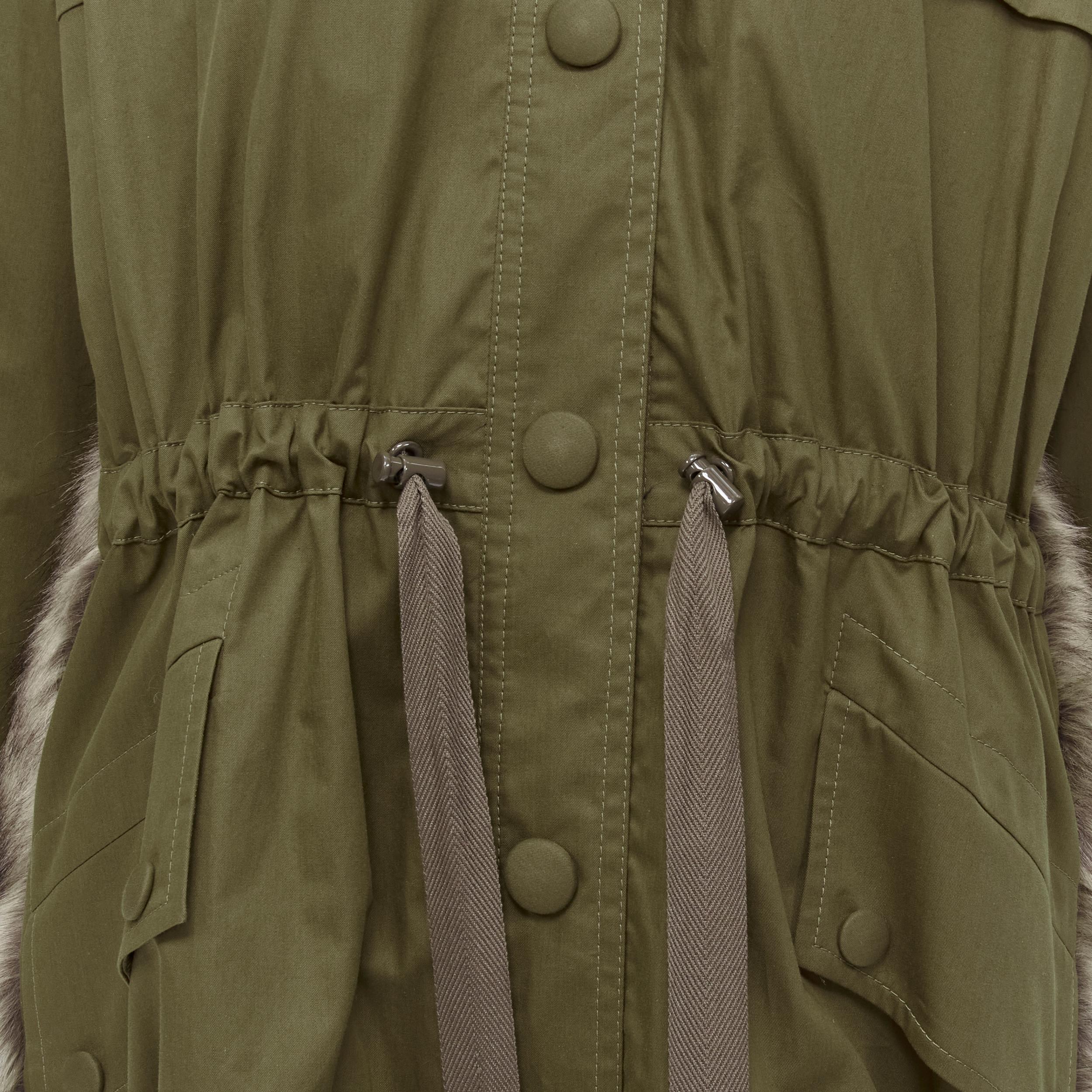 STELLA MCCARTNEY brown faux fur military green drawstring parka FR34 XS 
Reference: GIYG/A00124 
Brand: Stella McCartney 
Material: Cotton 
Color: Green 
Pattern: Solid 
Closure: Button 
Extra Detail: Drawstring at waist. Diamond quilted lining.