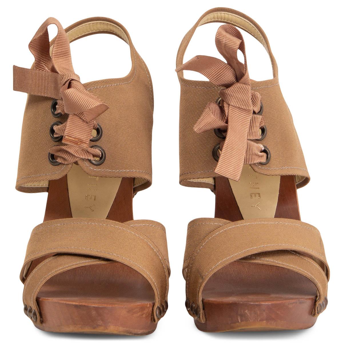 100% authentic Stella McCartney lace-up platform sandals with a brown wooden sole and heel featuring brown grosgrain fabric. Have been worn and are in excellent condition. 

Measurements
Imprinted Size	37
Shoe Size	37
Inside Sole	24cm