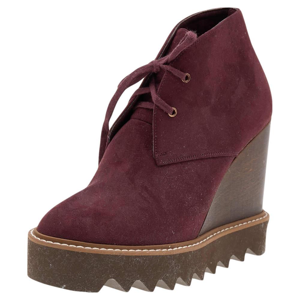 Add these stunning wedge-heeled boots from Stella McCartney to your closet today! Crafted from faux suede, these burgundy boots feature lace-ups and sturdy rubber soles for a comfortable finish. 