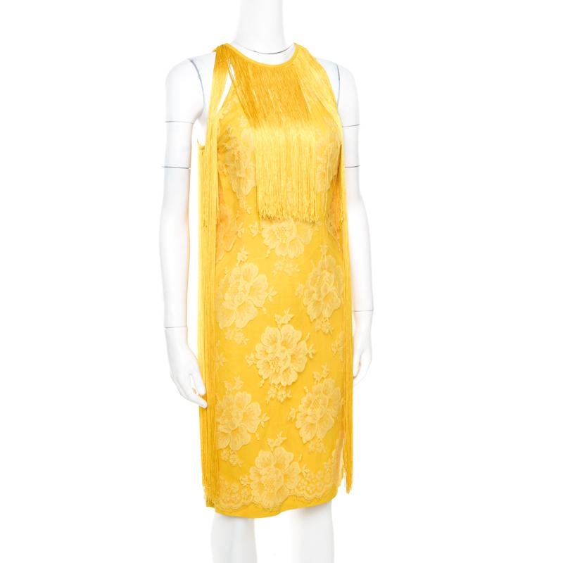 Vibrant and oh so stylish, this Stella Mccartney dress is sure to add oodles of style to your wardrobe and make you stand out like never before! This canary yellow creation is made of a blend of fabrics and features a floral lace design. It flaunts