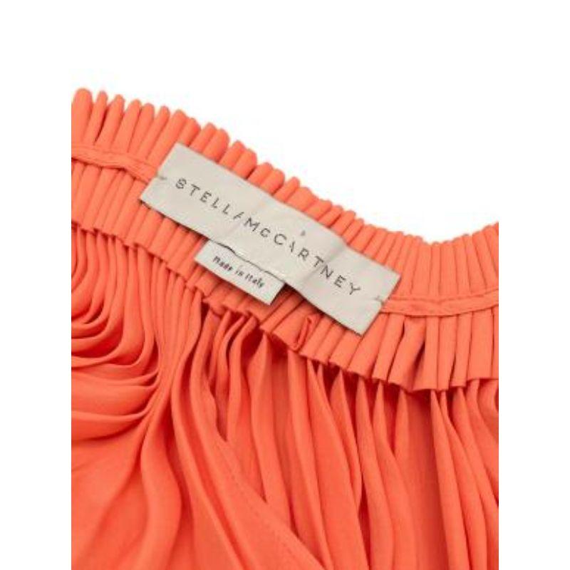 Stella McCartney Coral Pleated Trapeze Dress
 

 - Made of luscious silk.
 - trapeze style
 - Split at the sides. 
 - Frilled top.
 

 Made in Italy. 
 Do not wash.
 

 

 PLEASE NOTE, THESE ITEMS ARE PRE-OWNED AND MAY SHOW SIGNS OF BEING STORED