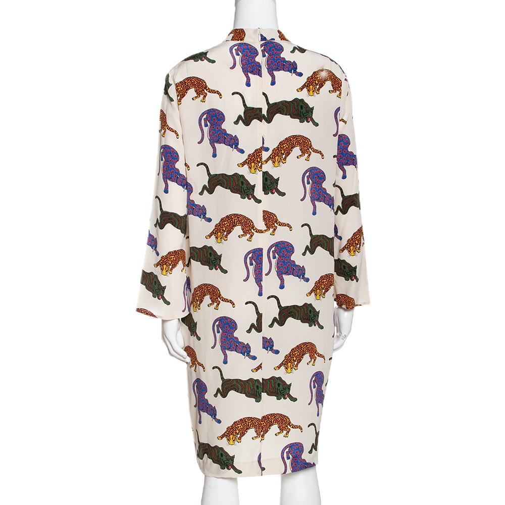 This stylish dress hails from the house of Stella McCartney. Crafted from silk, it comes in a lovely cream. It flaunts wild cat prints throughout, long sleeves, round neckline, a loose silhouette, two pockets and zip closure. You can pair it with
