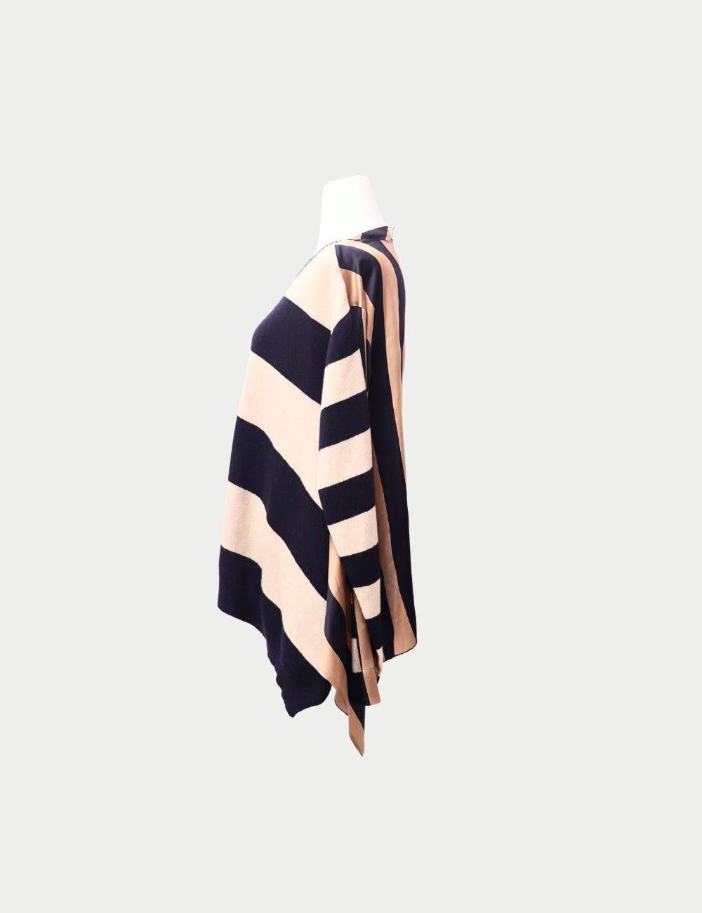 Stella McCartney Striped Knit Sweater

Add a touch of effortless luxury to your wardrobe with this Stella McCartney striped knit sweater. Crafted in soft fabric, this oversized pullover features bold beige and navy horizontal stripes, complemented