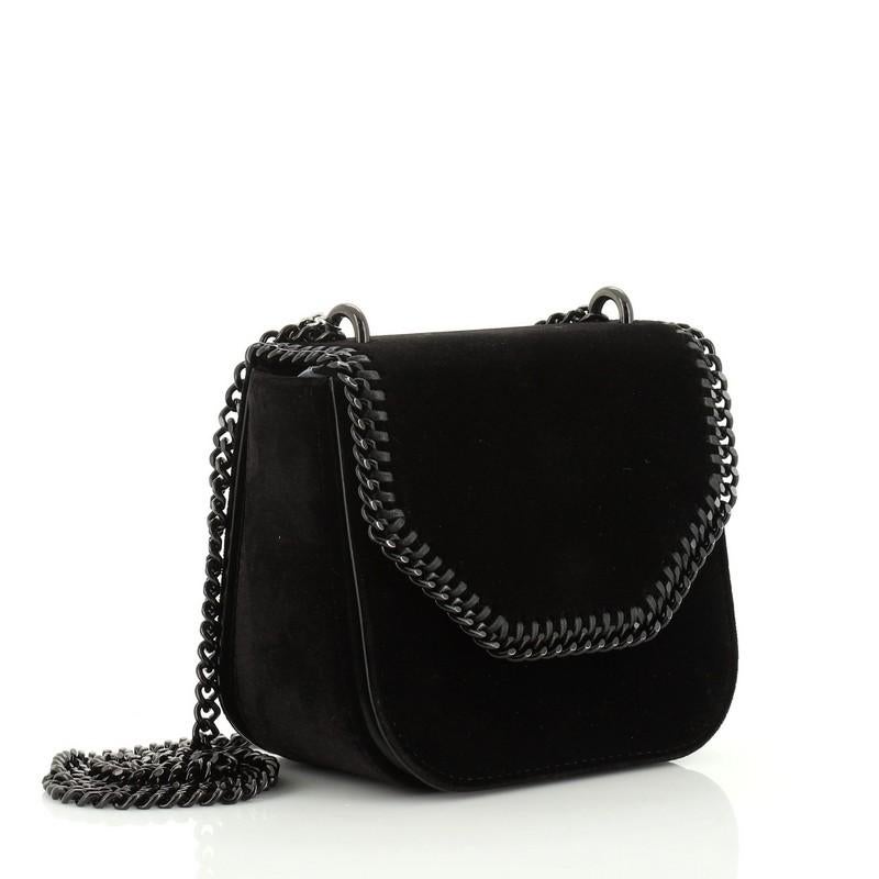 This Stella McCartney Falabella Box Shoulder Bag Velvet Mini, crafted in black velvet, features a chain link strap, whipstitch and curb-chain trim, and black-tone hardware. Its magnetic snap button closure opens to a yellow suede interior with side