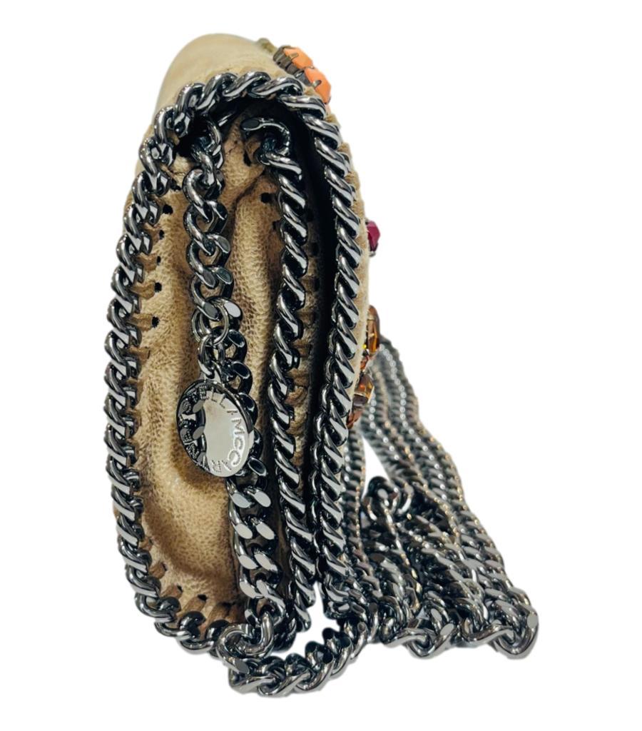 Stella McCartney Falabella Embroidered Clutch Bag

Beige bag designed with multicoloured bead and crystal arrows and question marks embellishments.

Trimmed with the style's signature gunmetal chain and detailed with 'Stella McCartney' logo engraved