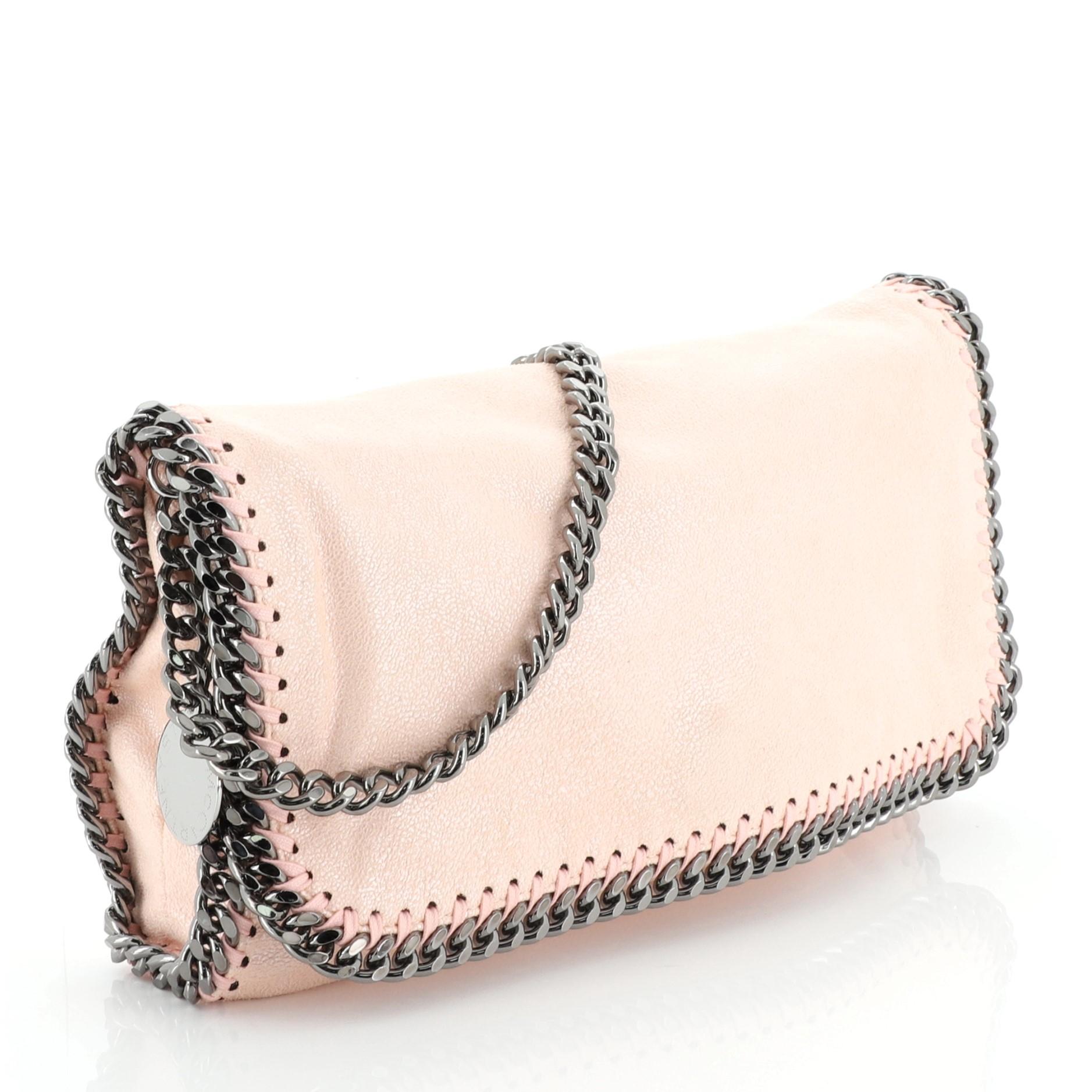 This Stella McCartney Falabella Flap Bag Shaggy Deer Small, crafted in pink shaggy deer, features chain link strap and trim, whipstitched edges, and gunmetal-tone hardware. Its hidden magnetic snap closure opens to a pink fabric interior with slip