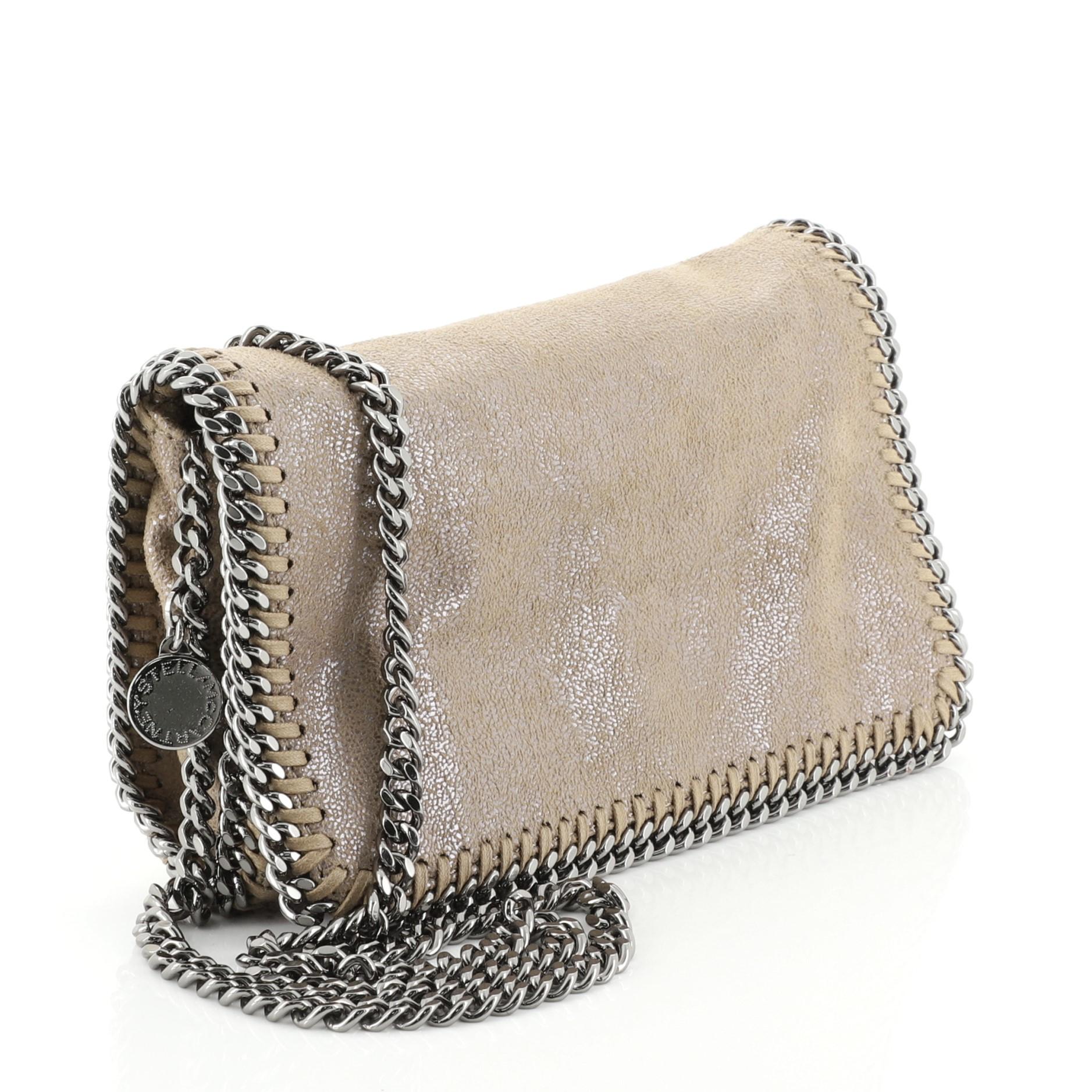 This Stella McCartney Falabella Flap Crossbody Bag Shaggy Deer Small, crafted from neutral shaggy deer, features chain link strap and trim, whipstitched edges, and gunmetal-tone hardware. Its flap with hidden magnetic snap closure opens to a pink